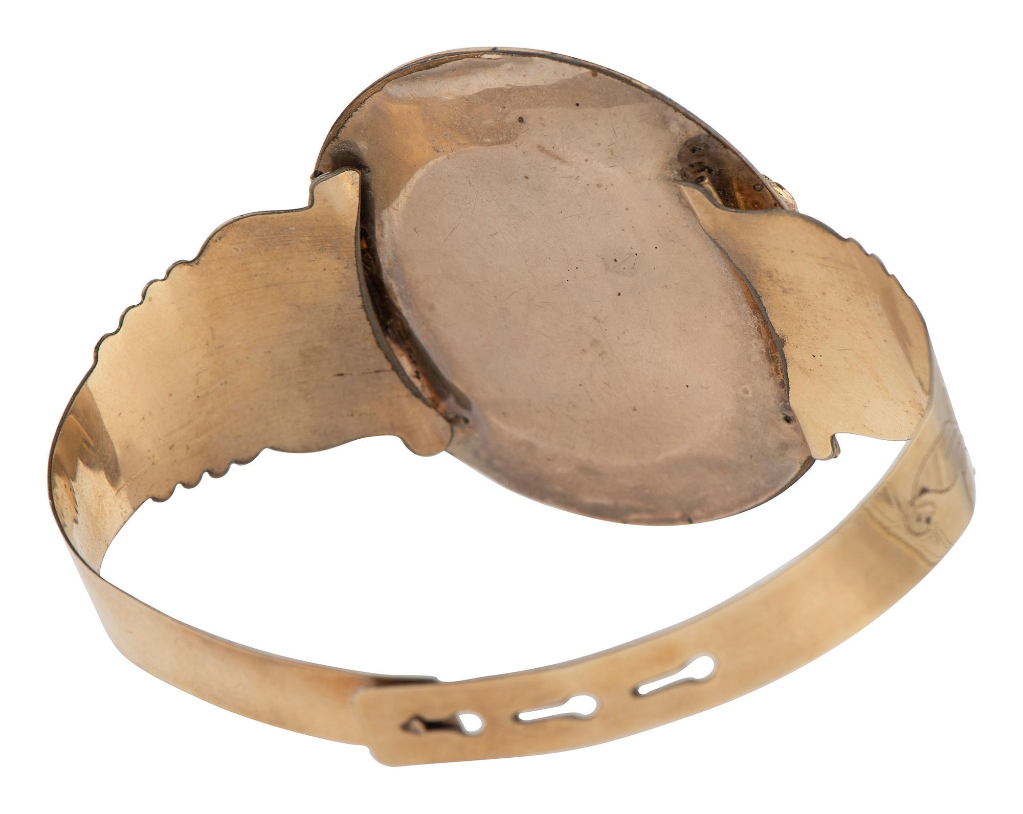 [EARLY PHOTOGRAPHY]. Daguerreian "sweetheart" 10K gold cuff containing portrait of young woman.
