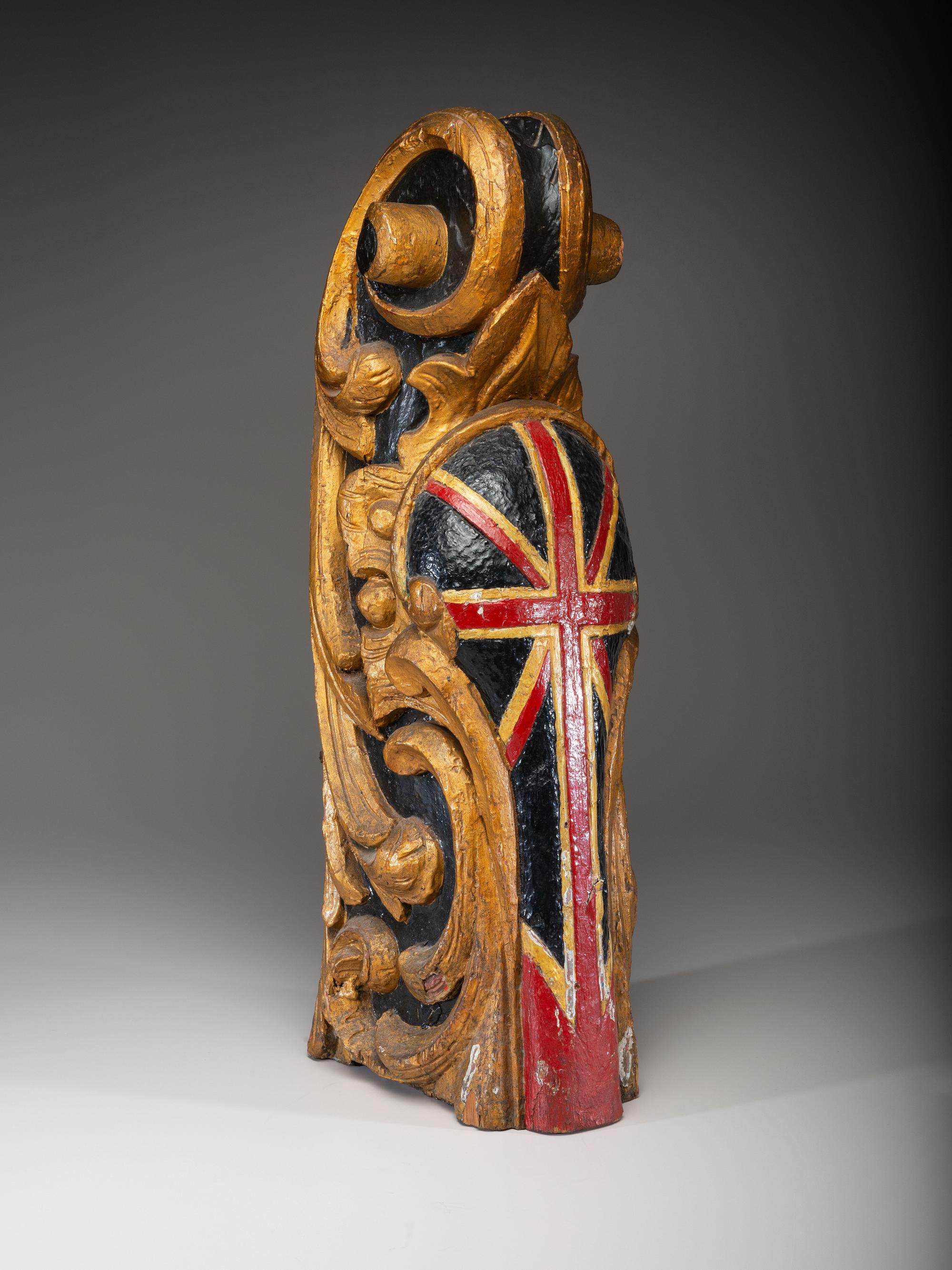 A Carved and Parcel Gilt Union Jack Mast Head