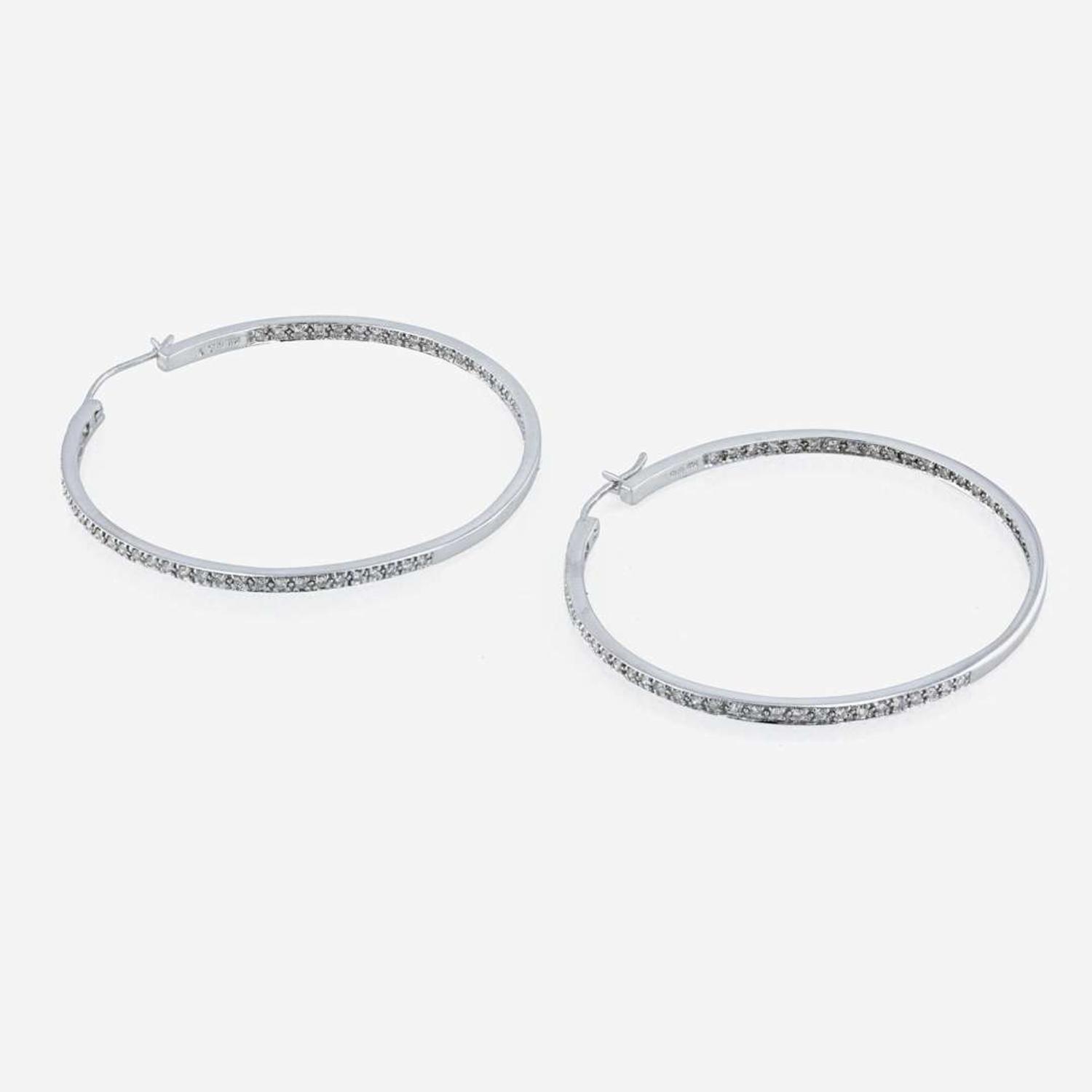 A pair of 14K white gold and diamond hoop earrings