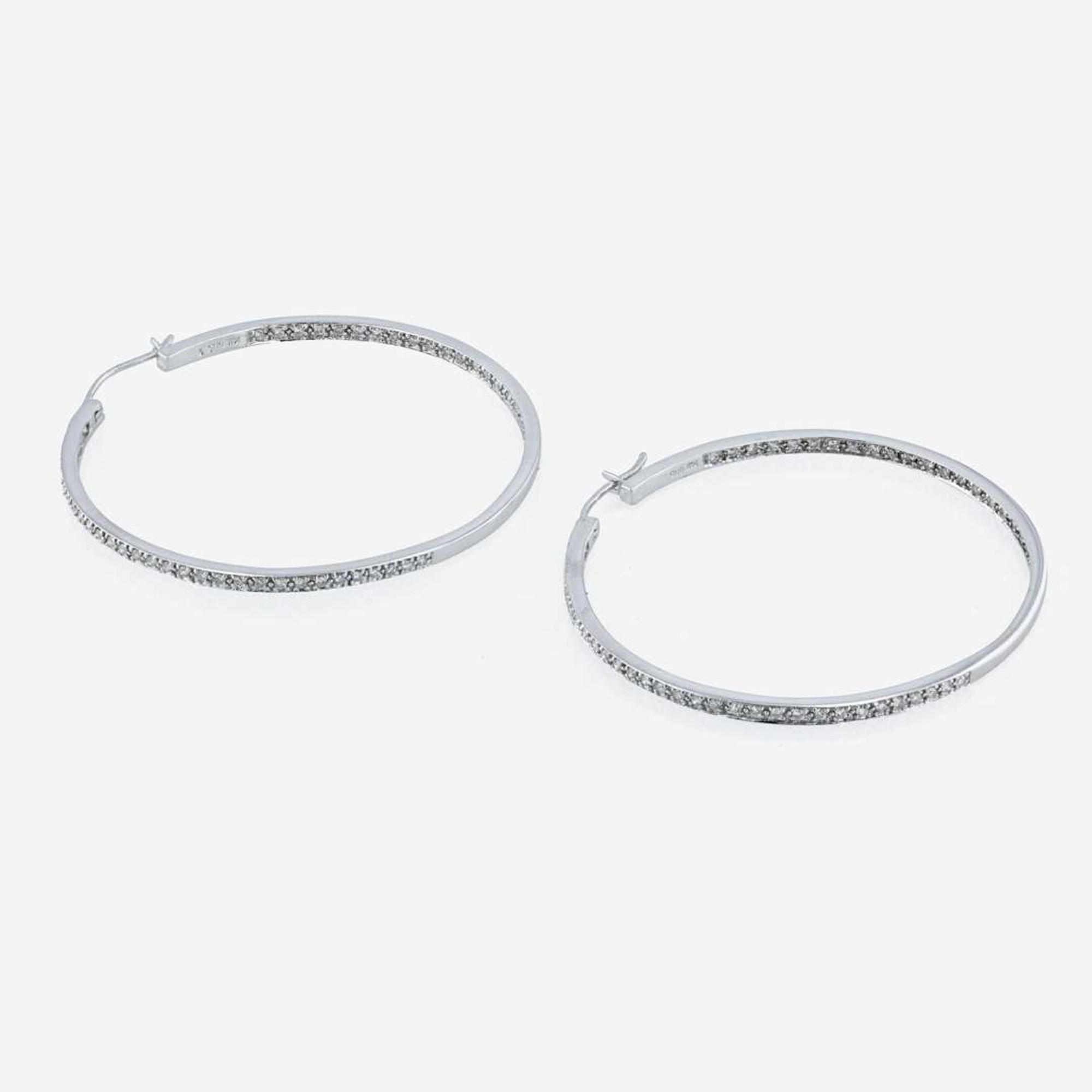 A pair of 14K white gold and diamond hoop earrings