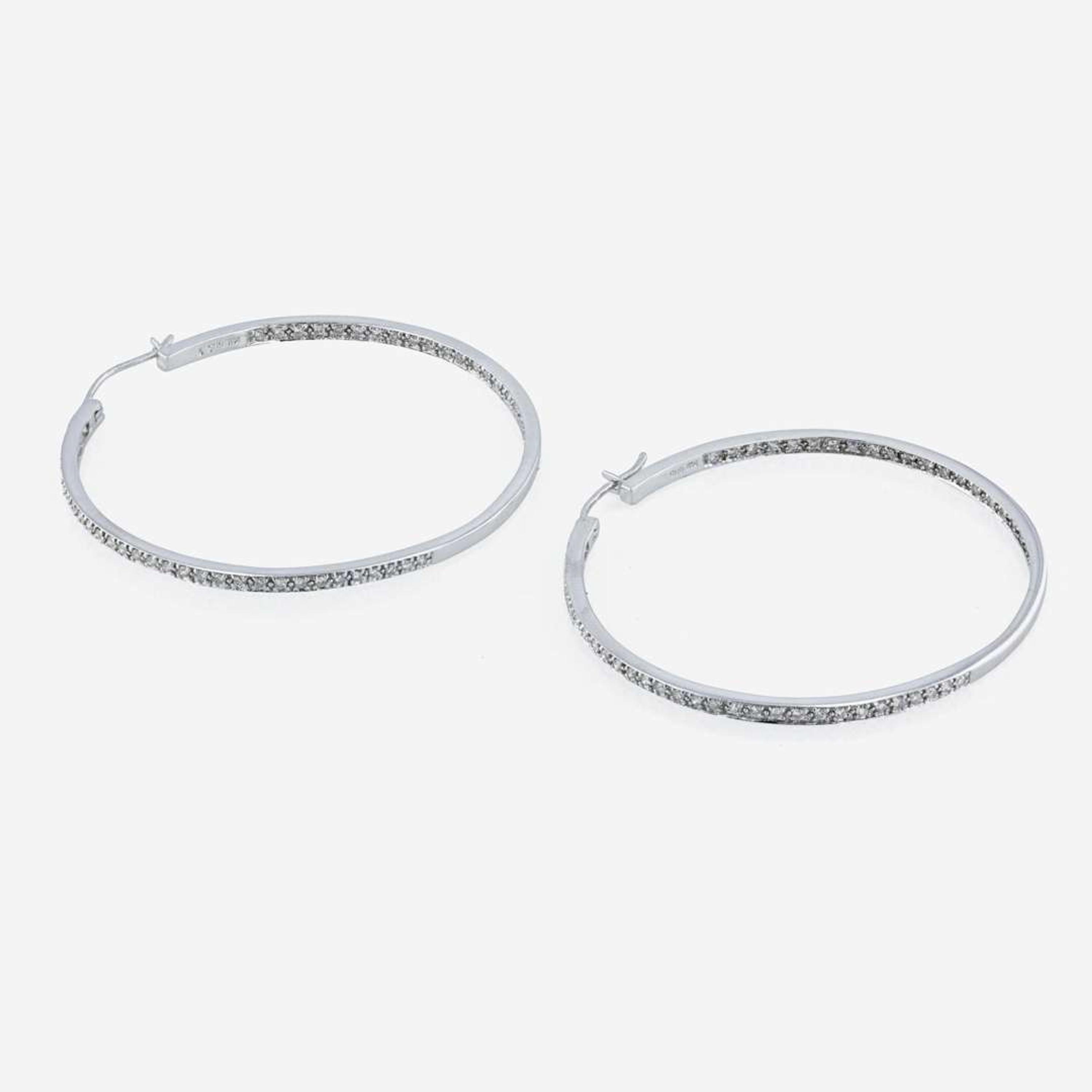 A pair of 14K white gold and diamond hoop earrings