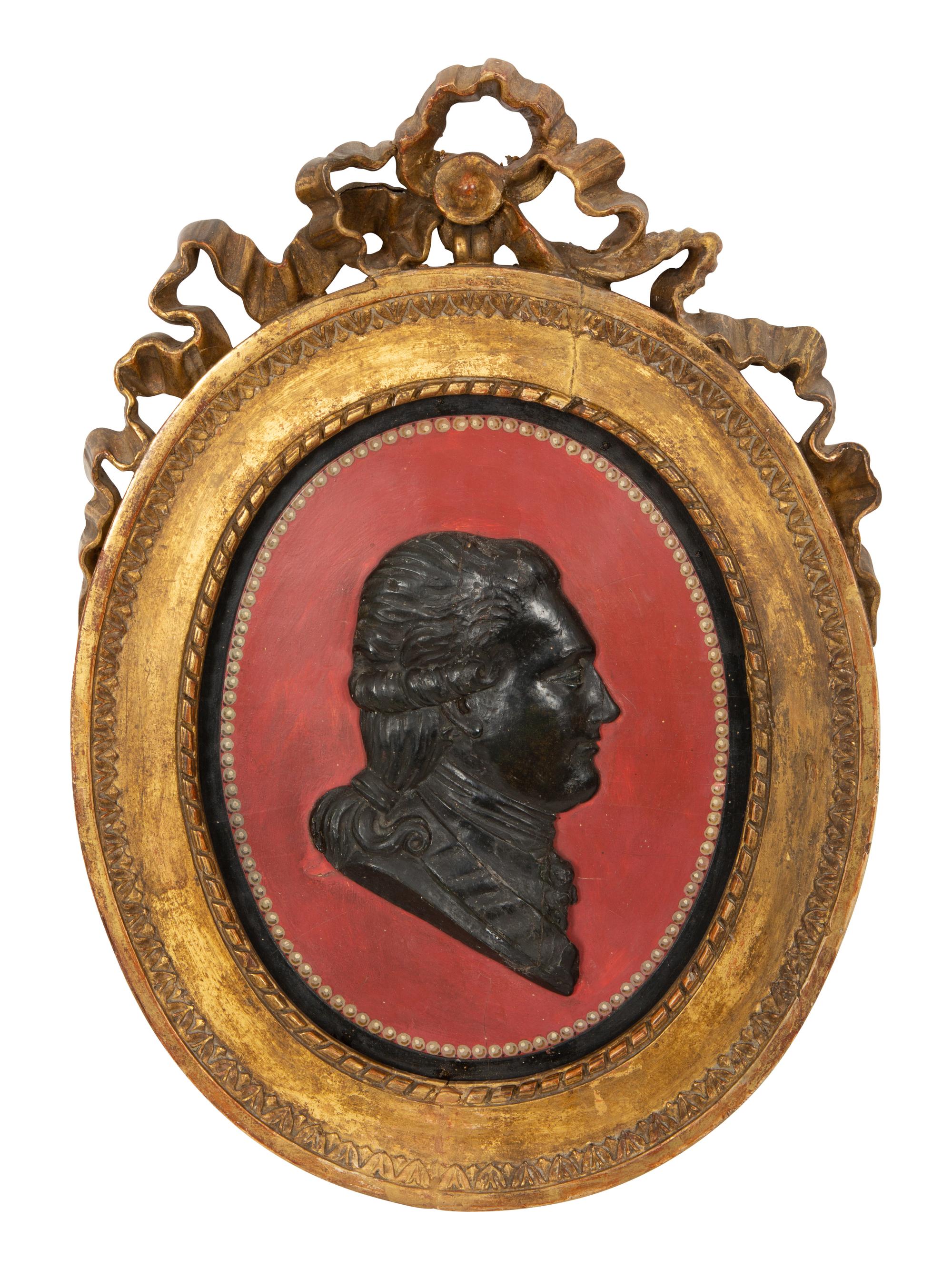 A Pair of Giltwood Framed Ebonized Relief Portrait Plaques of French Nobility, 18th Century