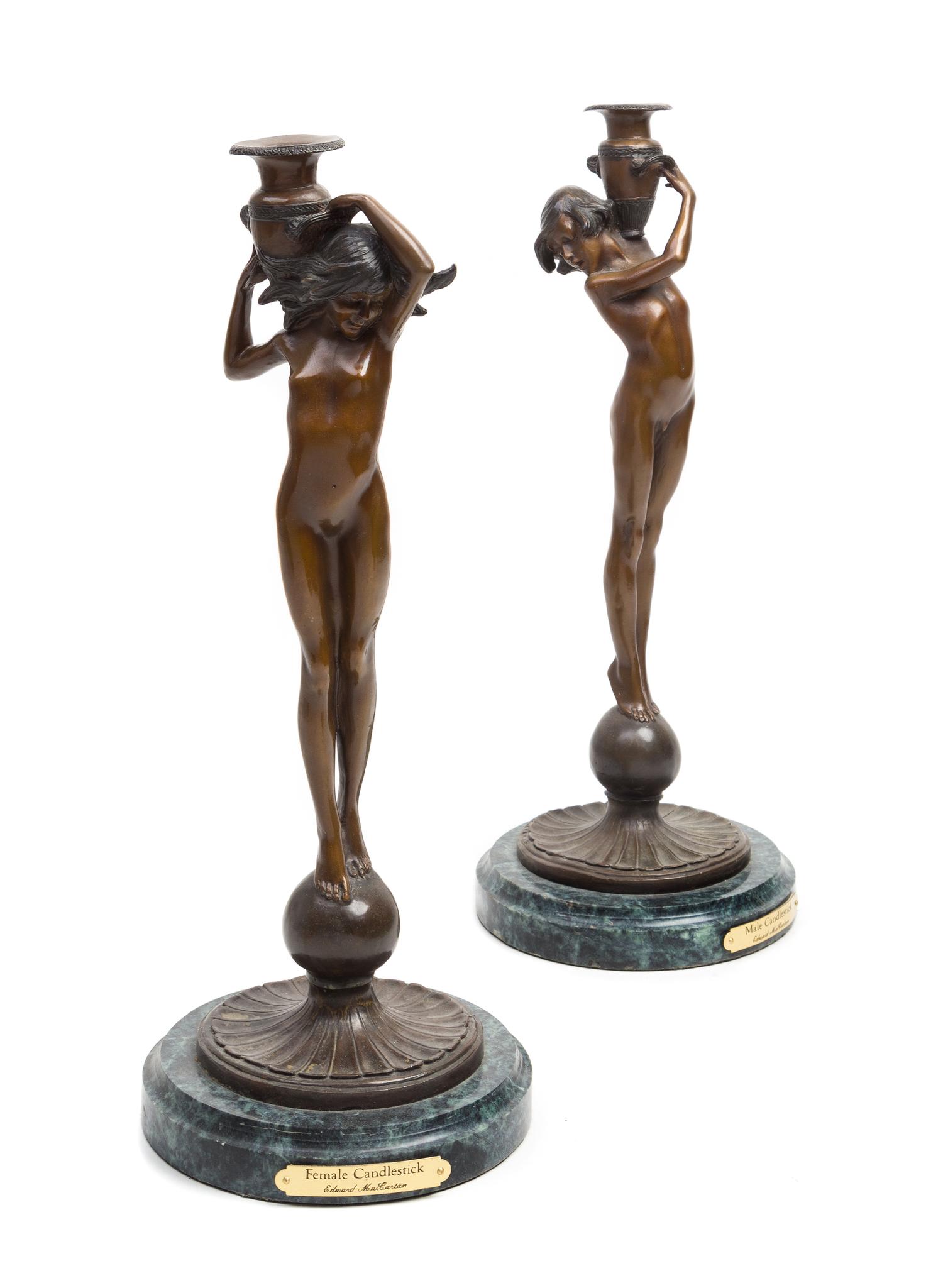 A Pair of American Bronze Figural Candlesticks Height of first 17 1/2 inches, — AFTER EDWARD McCARTAN