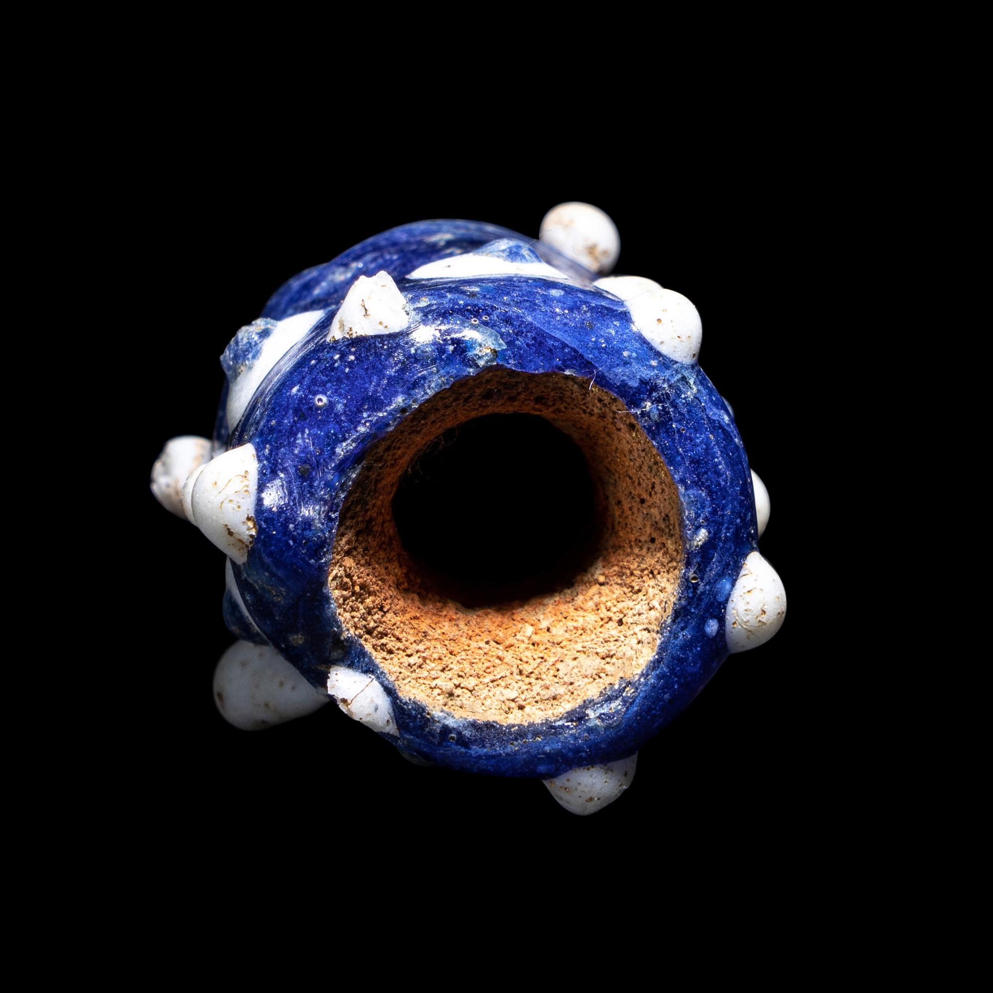 A Phoenician Glass Triple-Face Bead