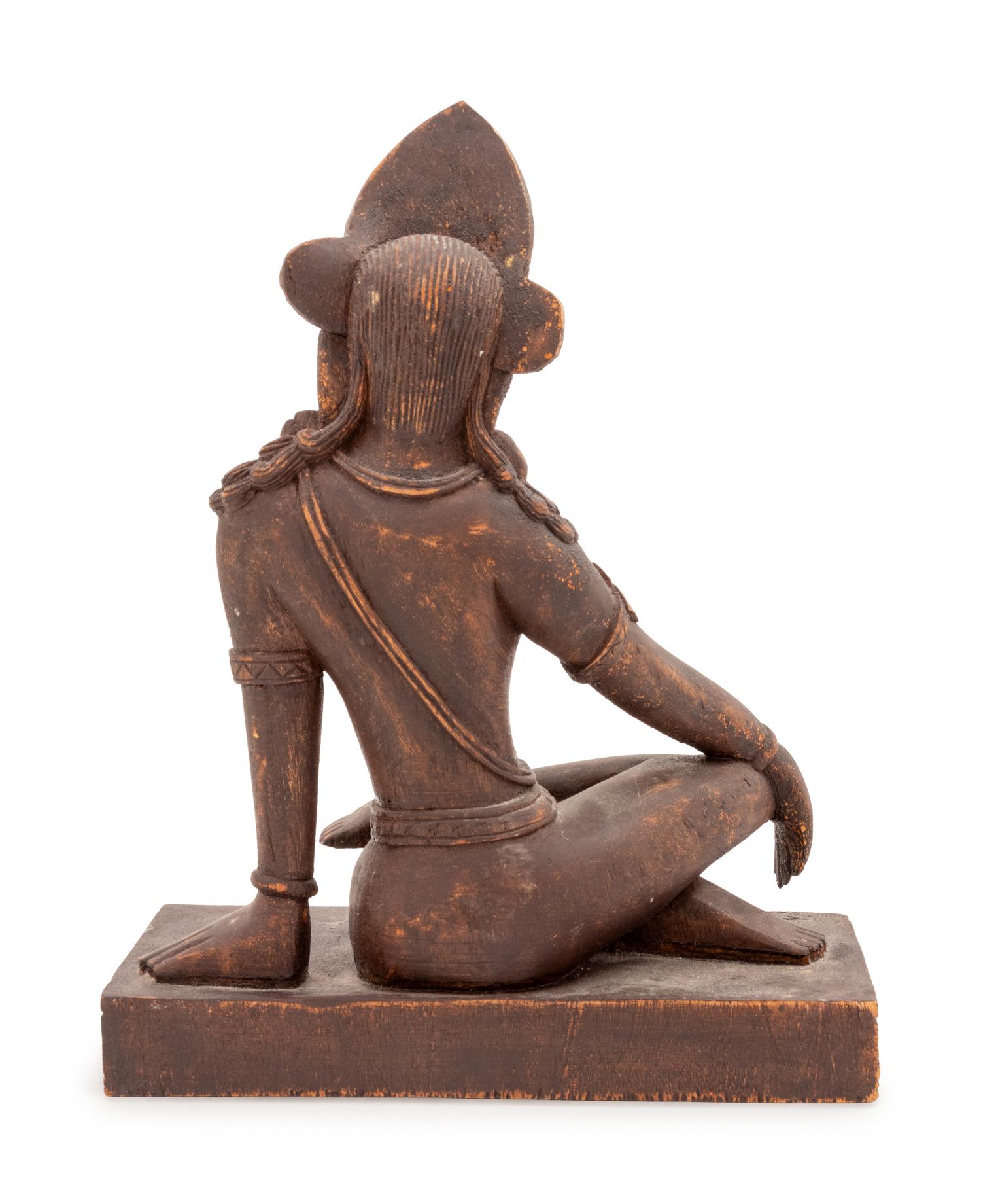 An Indian Carved Wood Figure of a Seated Deity