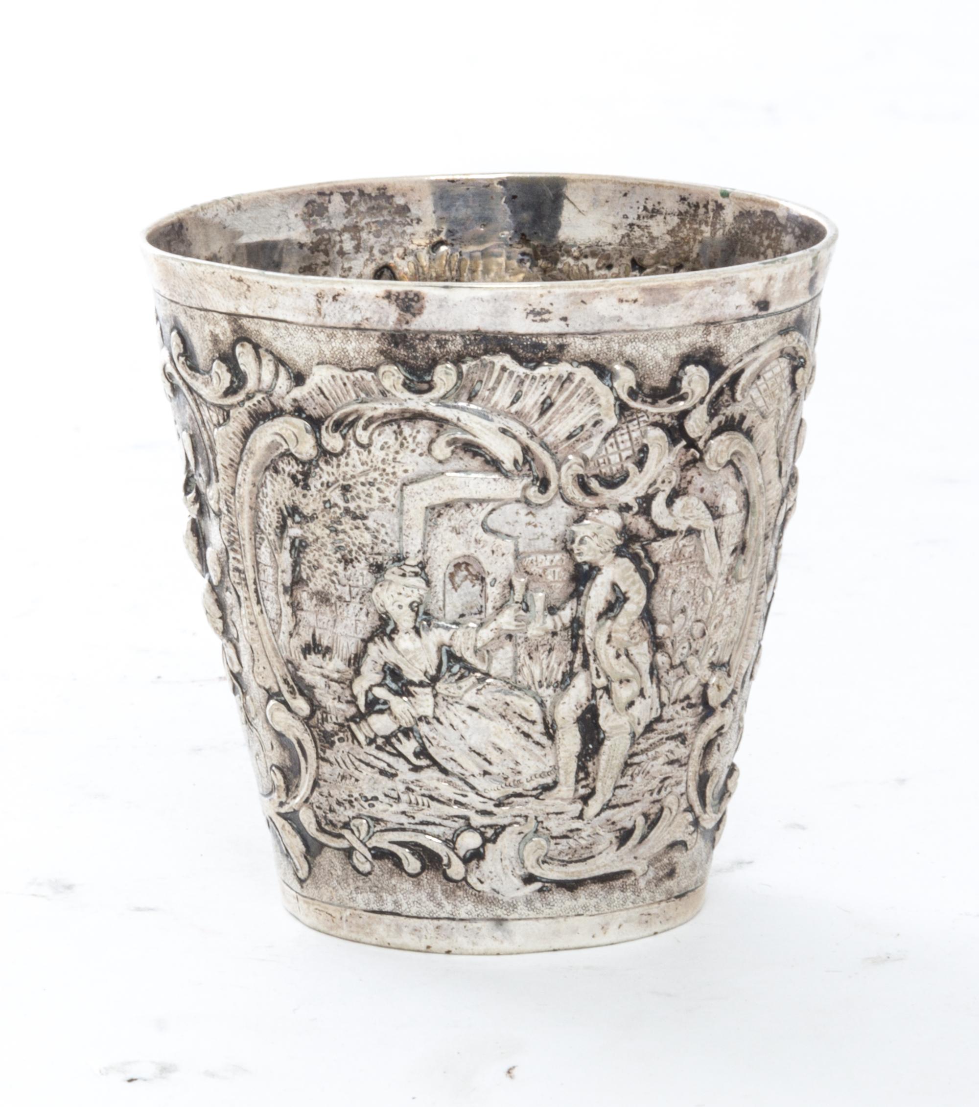 A German Silver Beaker, Georg Roth & Co., Hanau, worked to show scenes of courting couples with C-scroll and foliate decorated borders.