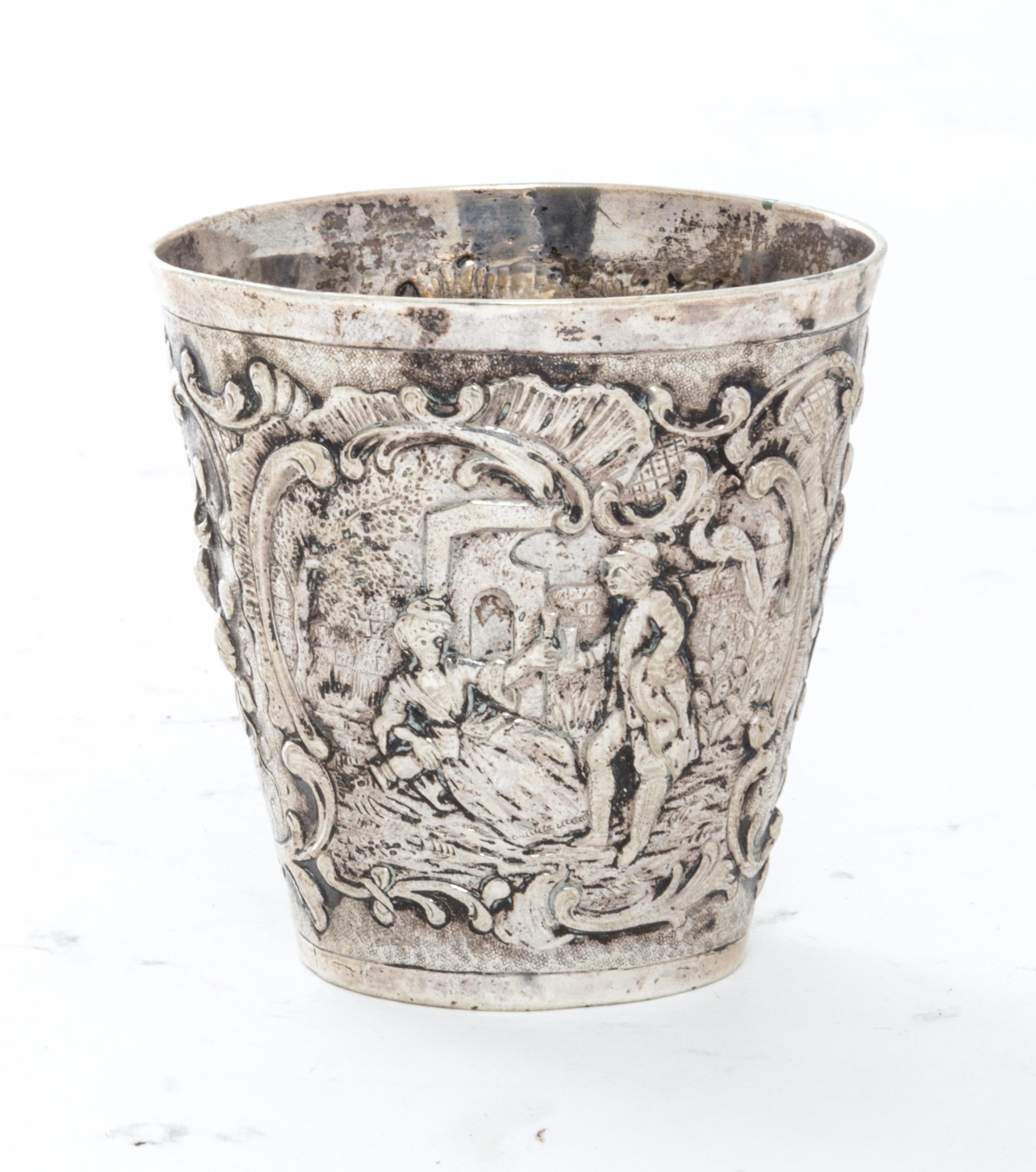A German Silver Beaker, Georg Roth & Co., Hanau, worked to show scenes of courting couples with C-scroll and foliate decorated borders.