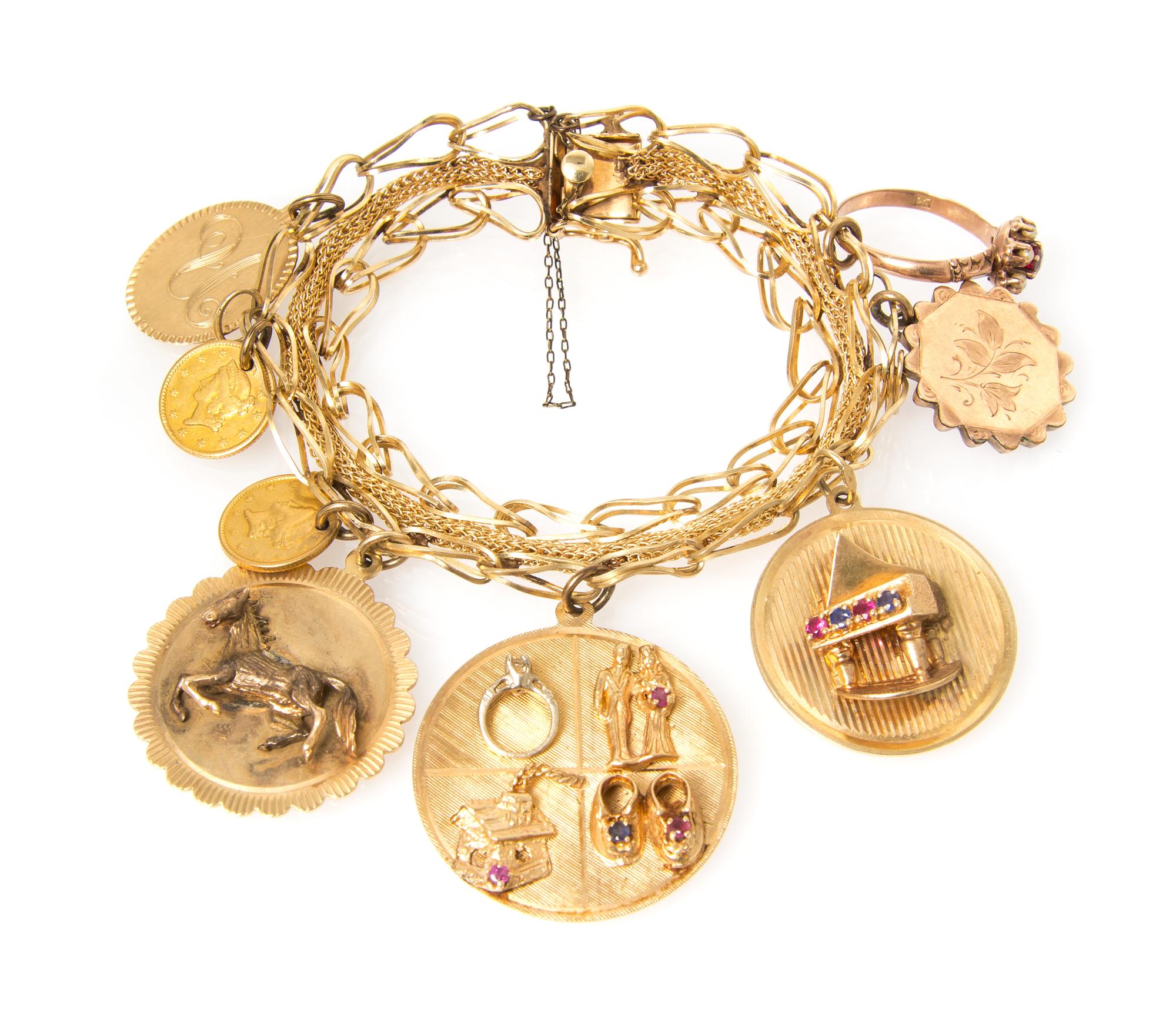 A 14 Karat Yellow Gold Charm Bracelet with Eight Attached Charms, 31.10 dwts.