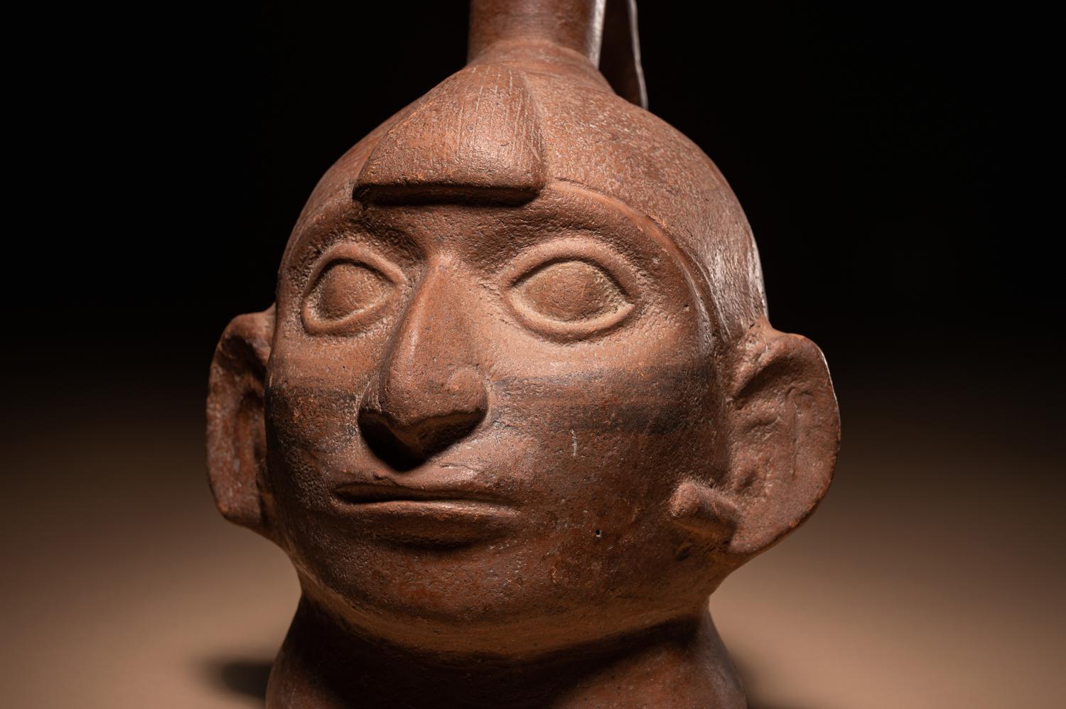 A Moche Warrior Face Stirrup Vessel