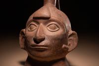 A Moche Warrior Face Stirrup Vessel