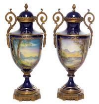 A Pair of Sevres Style Gilt Bronze Mounted Porcelain Urns Height 15 3/8 inches.