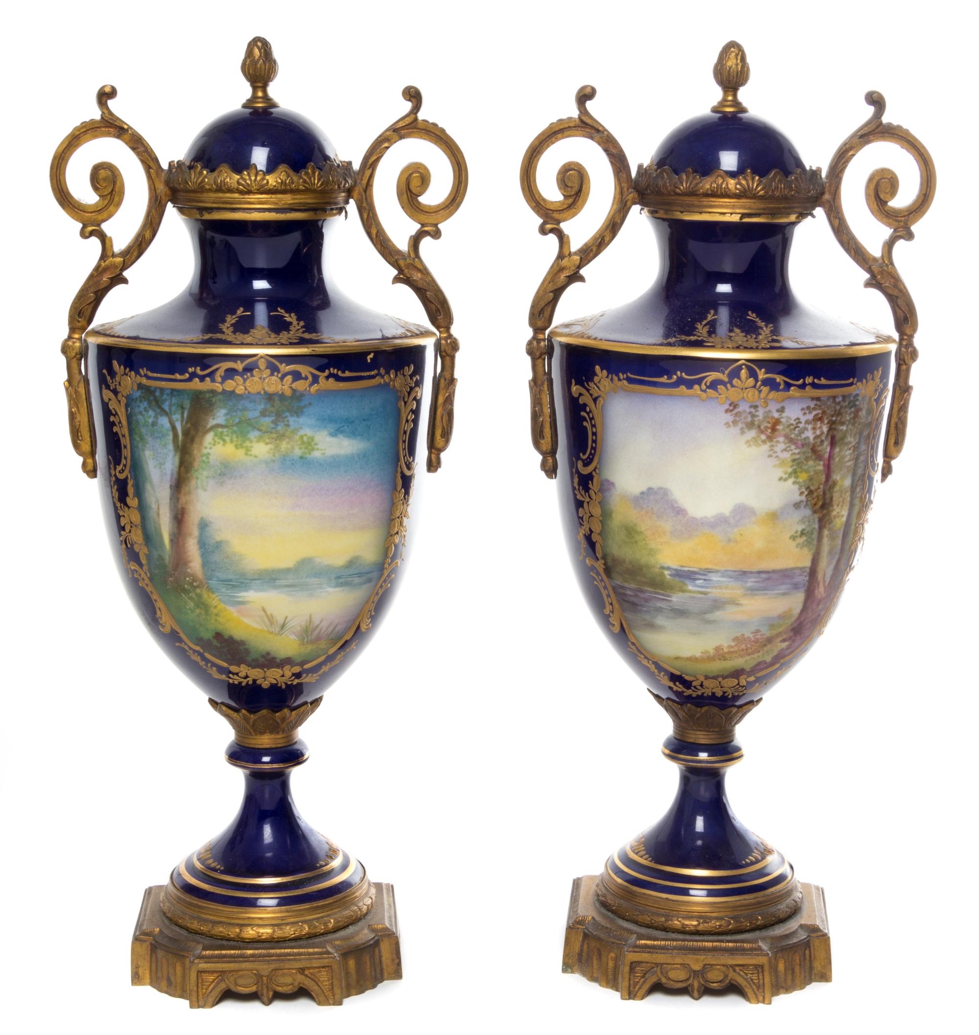 A Pair of Sevres Style Gilt Bronze Mounted Porcelain Urns Height 15 3/8 inches.