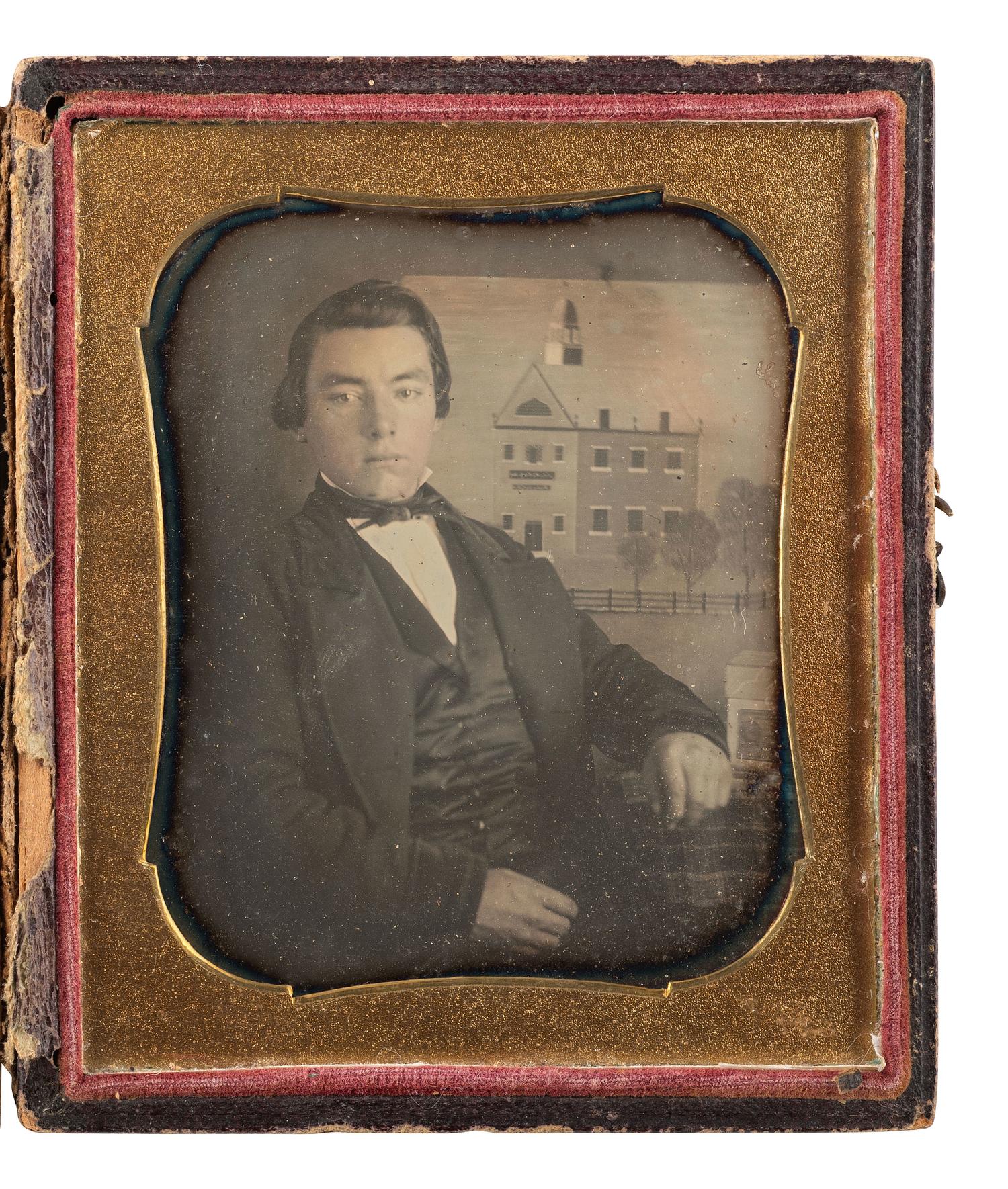 [EARLY PHOTOGRAPHY]. Sixth plate daguerreotype of a painter posed before a folk art painting, with daguerreotype plates resting on the table beside him.