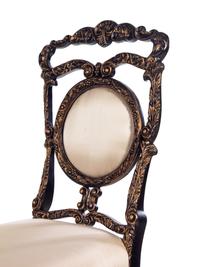 A Pair of Louis XV Style Ebonized and Gilded Side Chairs