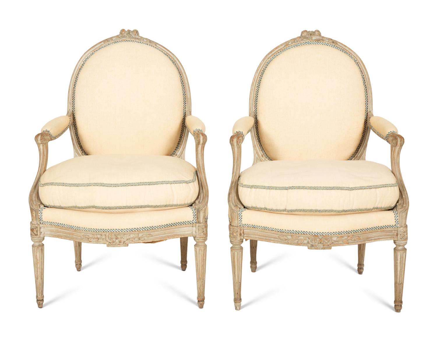 A Set of Four Louis XVI Grey-Painted and Parcel Gilt Fauteuils