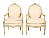 A Set of Four Louis XVI Grey-Painted and Parcel Gilt Fauteuils