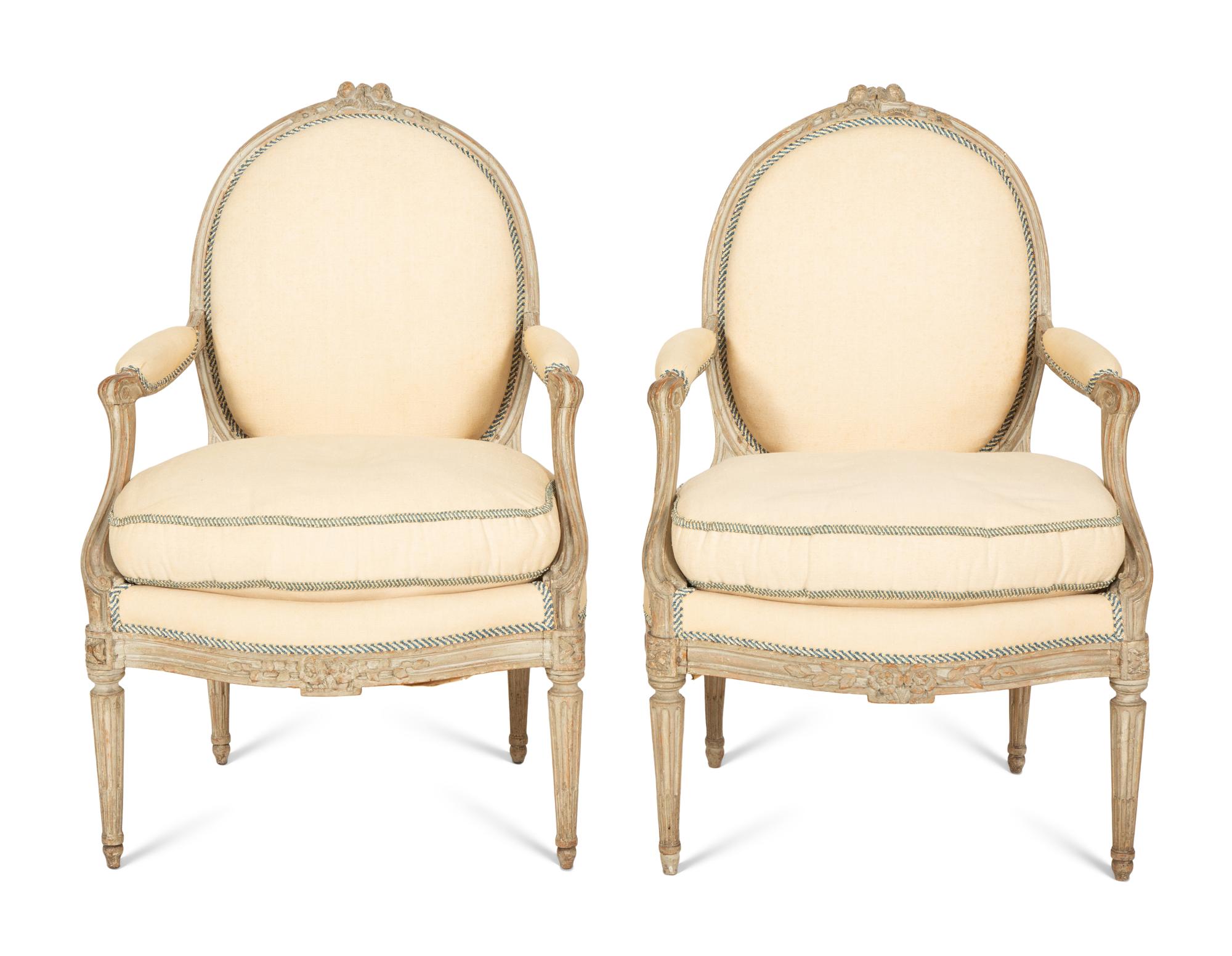 A Set of Four Louis XVI Grey-Painted and Parcel Gilt Fauteuils