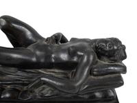 A Cast Bronze Figure of a Reclining Nude Woman