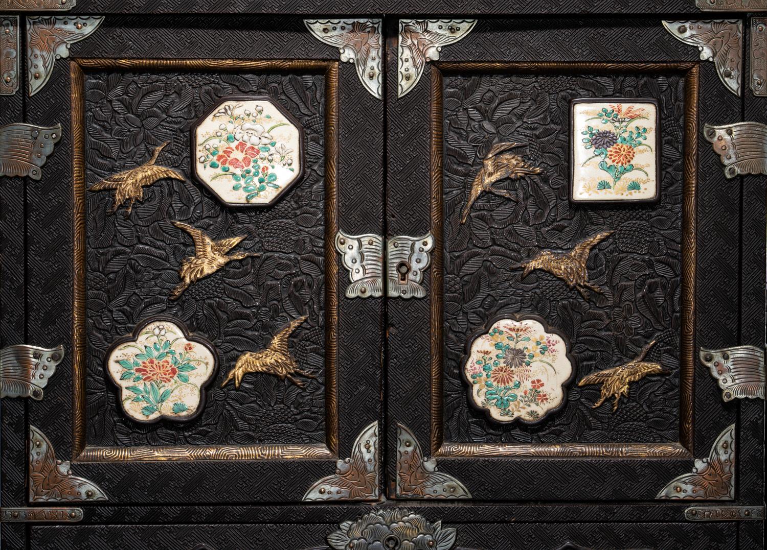 A Japanese Porcelain and Metal Inset Wood Chest
