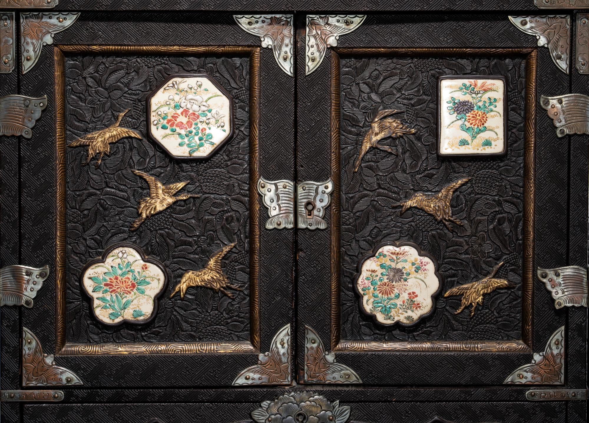A Japanese Porcelain and Metal Inset Wood Chest