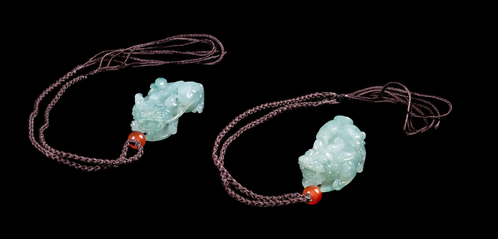 A Pair of Jadeite Figures of Mythical Beasts Length of each 1 3/4 inches. — 20TH CENTURY