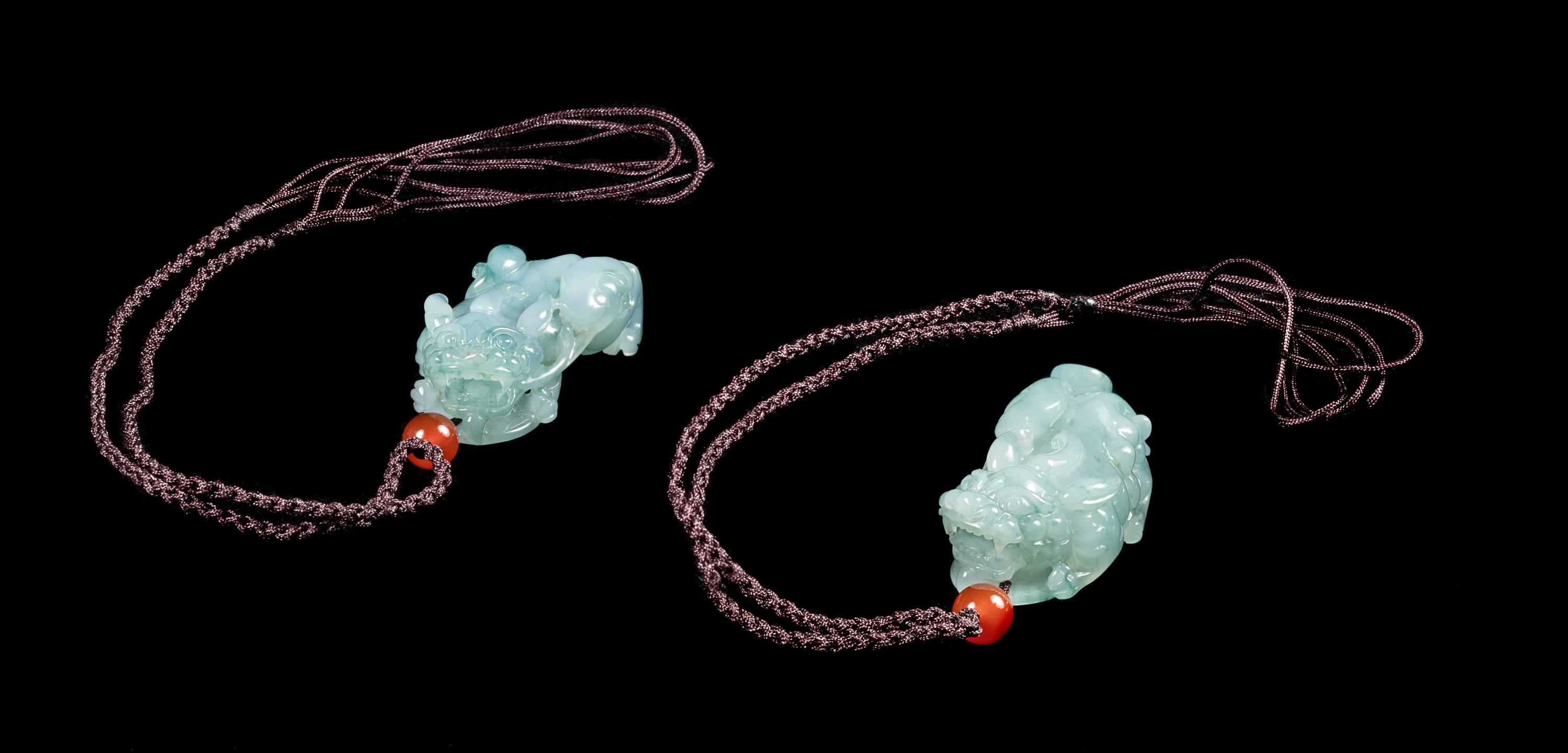 A Pair of Jadeite Figures of Mythical Beasts Length of each 1 3/4 inches. — 20TH CENTURY