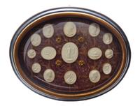 A Collection of Grand Tour Plaster Intaglios, Width of frame 17 inches.