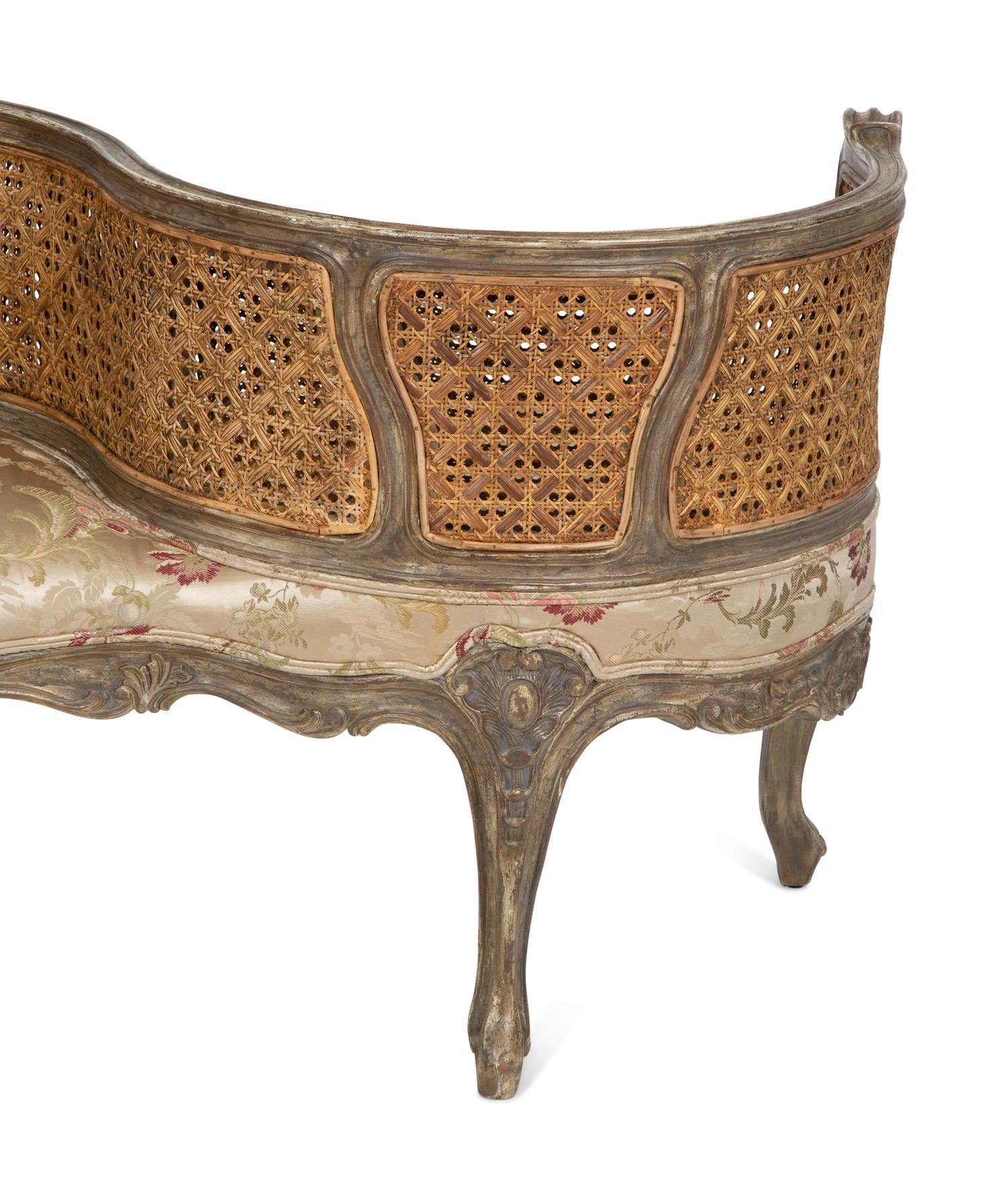 A Louis XV Style Painted Cane Back Tete-a-Tete