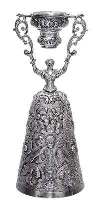 A German Silver Wager Cup, I.F. & Son Ltd., in the form of a maiden holding a swiveling cup aloft, her dress forming a larger cup, work