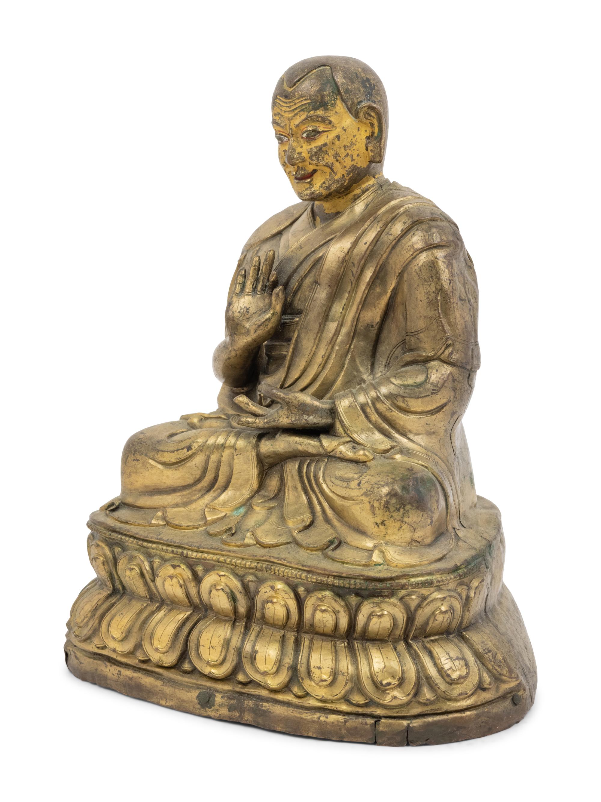 A Large Tibetan Parcel Gilt Bronze Repoussé Figure of a Seated Monk