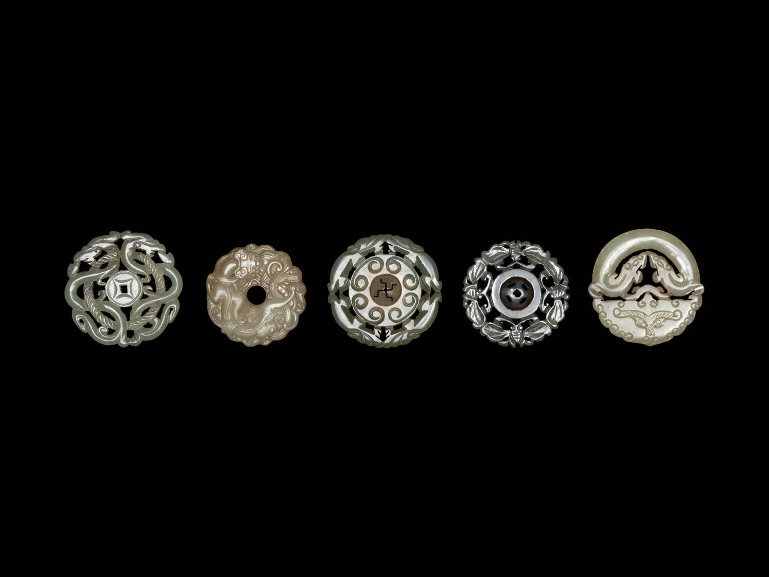 Five Chinese Pale Celadon Jade Carved and Reticulated Circular Pendants
