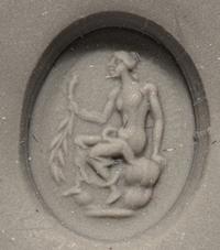 A Roman White Glass Ring Stone with Andromache or Calliope Seated and Holding a Palm Branch
