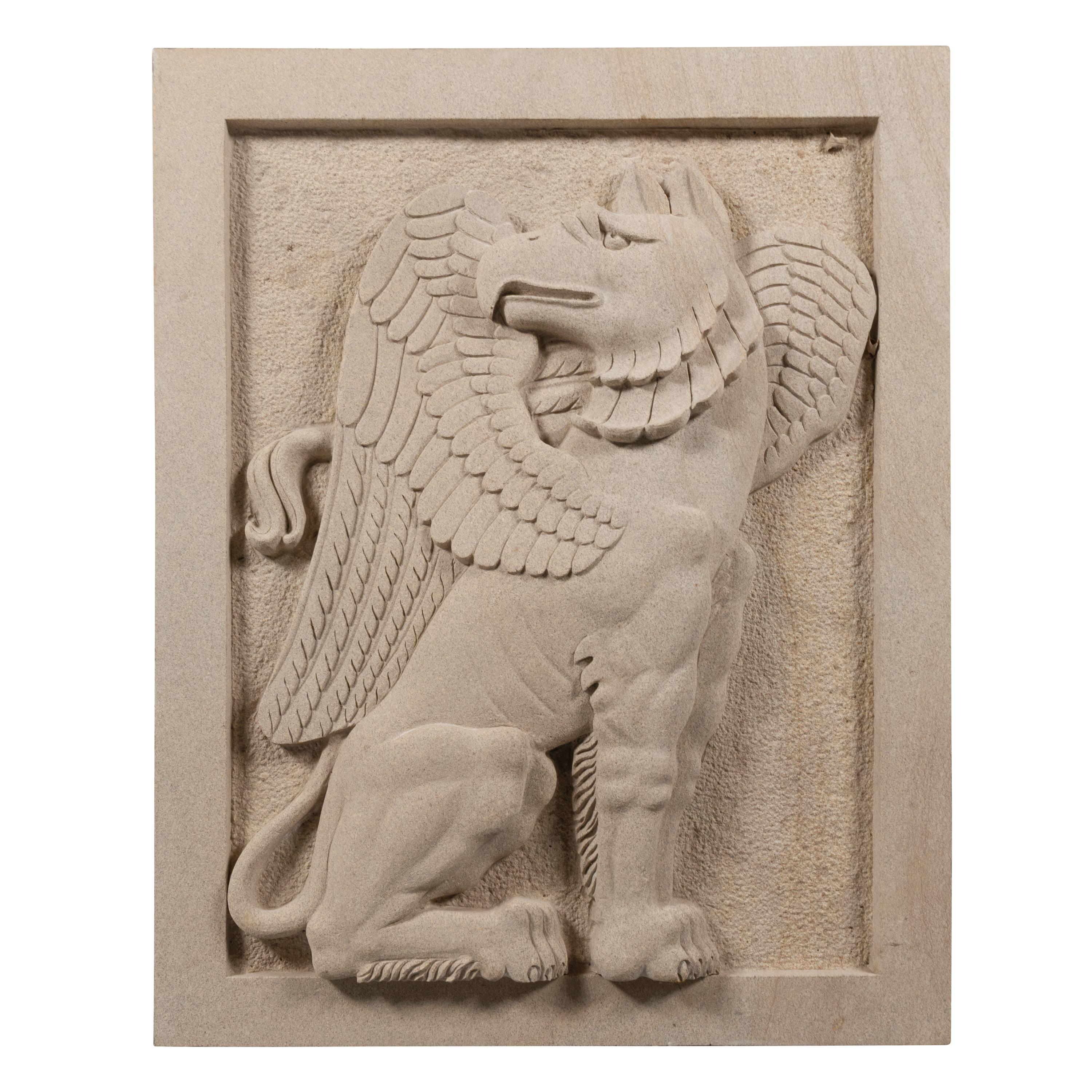 A Pair of Large Carved Granite Reliefs of Griffins