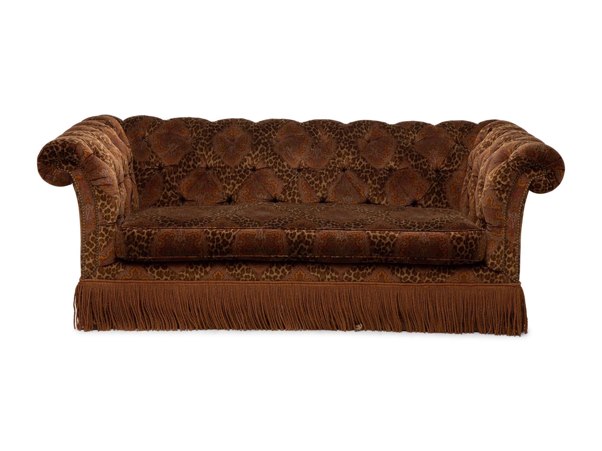 A Chesterfield Style Velvet-Upholstered Sofa with a Fringed Skirt
