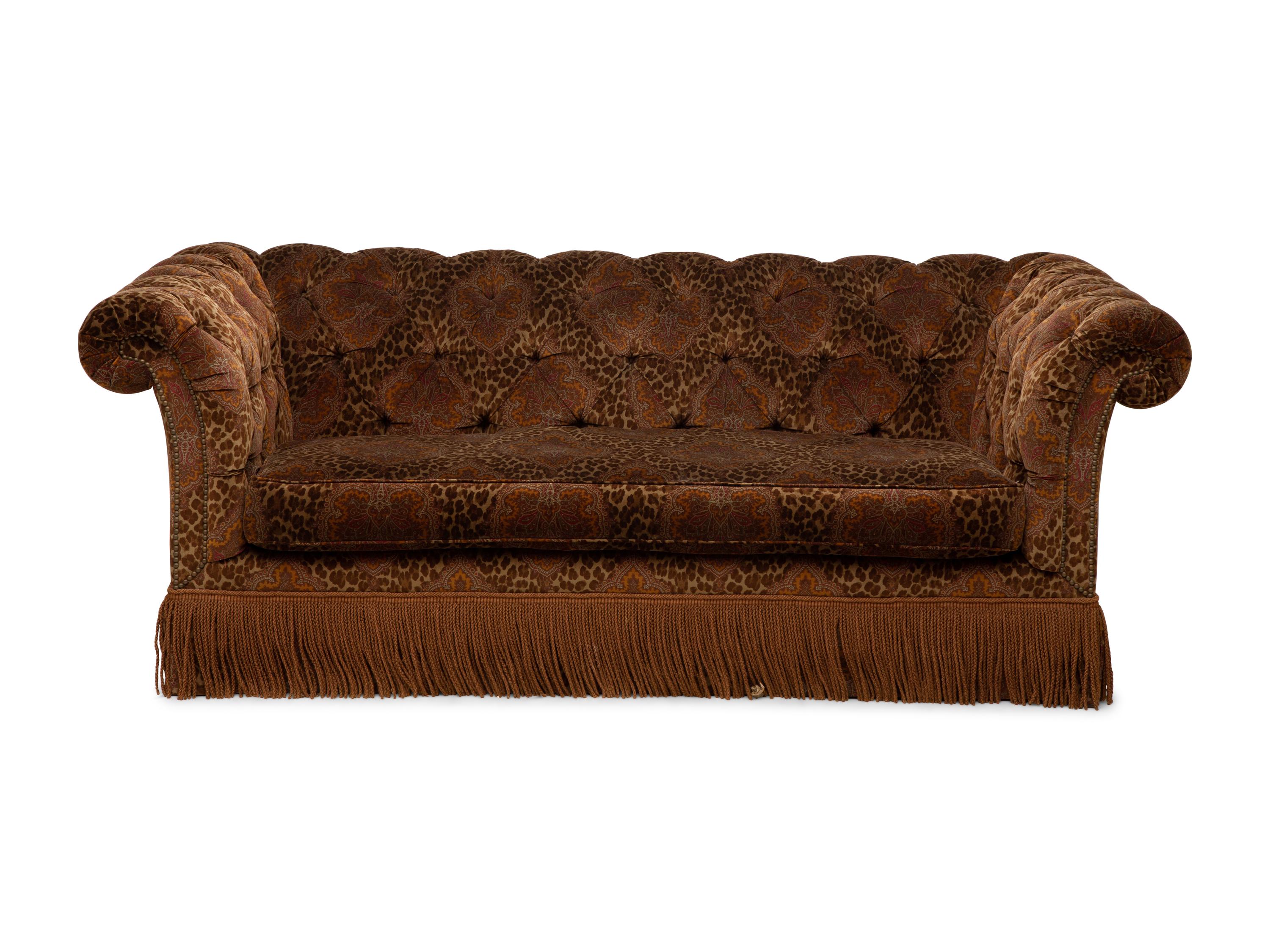A Chesterfield Style Velvet-Upholstered Sofa with a Fringed Skirt