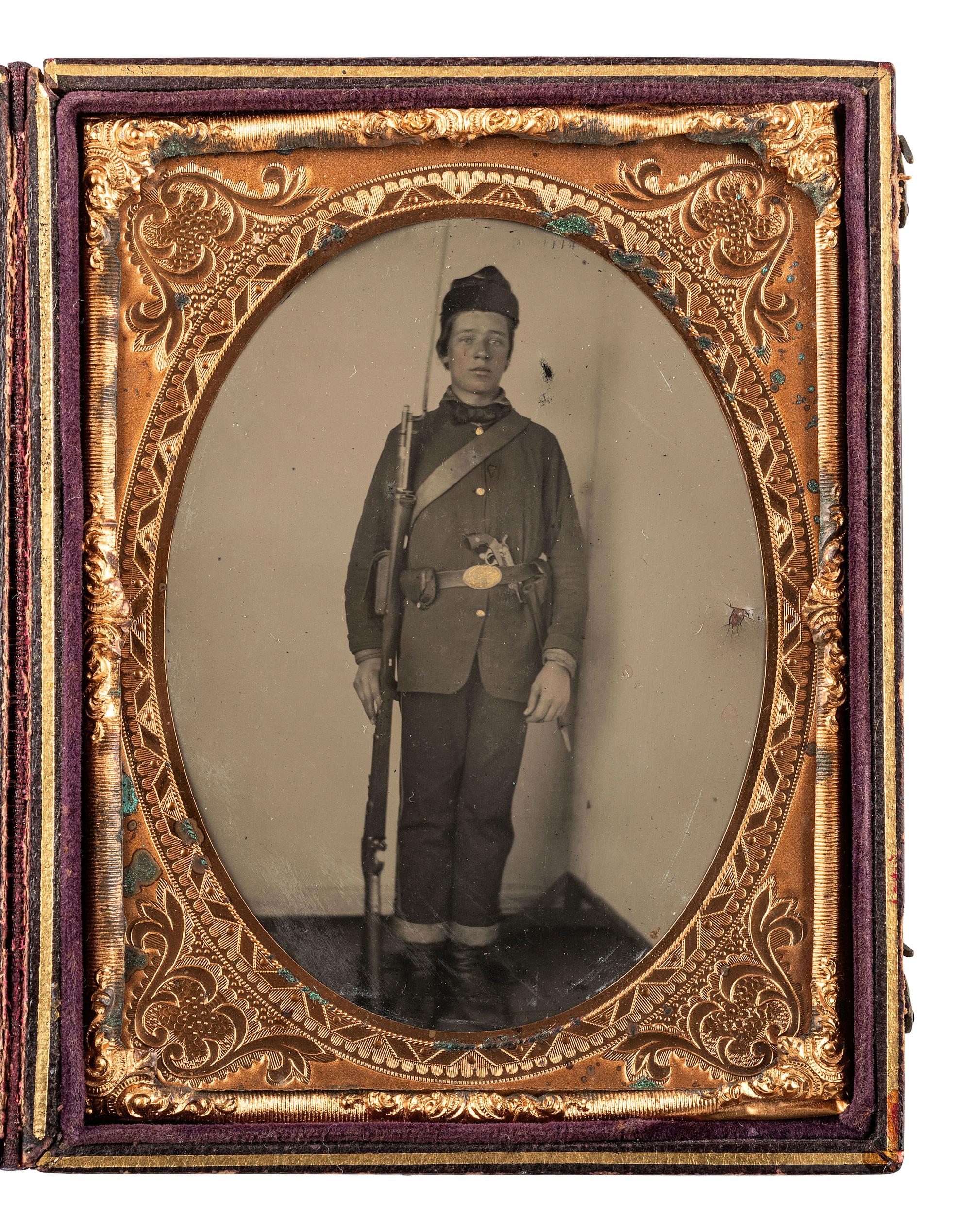 [CIVIL WAR]. Quarter plate tintype portrait of a very young, doubly armed private.