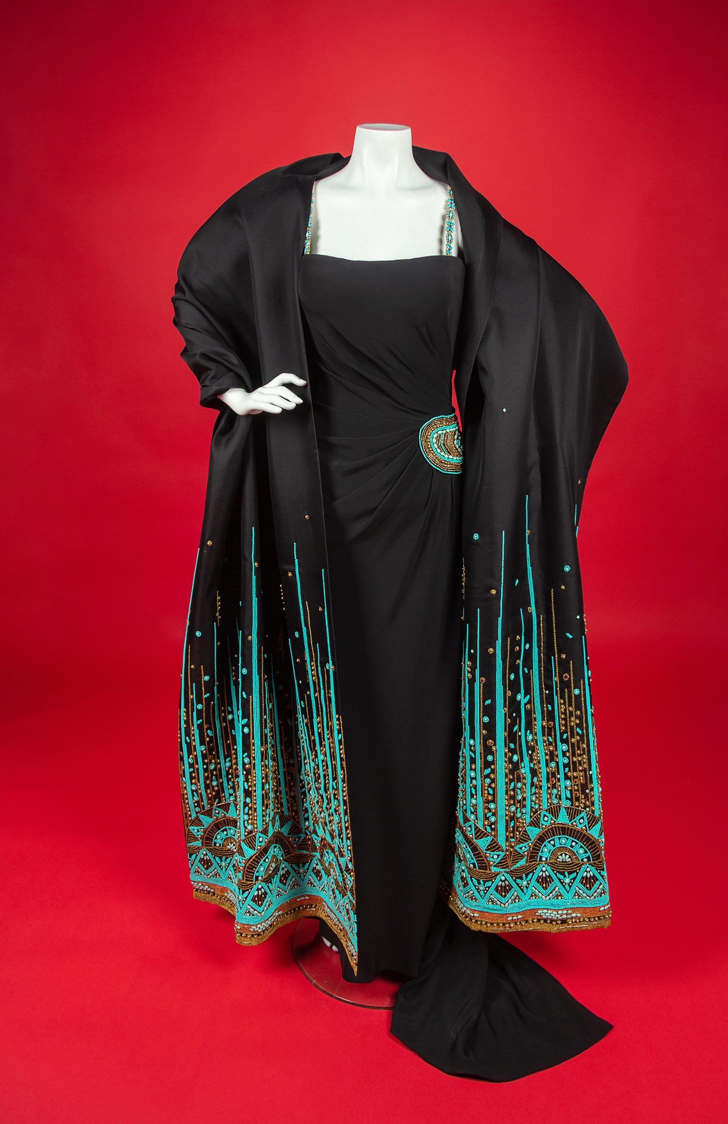 Christian Dior Haute Couture Dress and Shawl, 2008 — In 2008, Renée Fleming was the first woman to open the season of New York’s Metropolitan Opera. For the occasion, she wore four haute couture creations, including this dress by John Galliano for Christian Dior for her role as The Countess in Strauss’s Capriccio. Annie Lebovitz photographed Fleming in all four dresses for a 2008 Vogue article called ‘La Dolce Vida’ by Hamish Bowles. In the article, Galliano is quote as saying that Fleming’s voice, with its ‘whole timbre of colors, emotions, and tones, made me want to create something bold, vivacious, sensual, and capricious.’