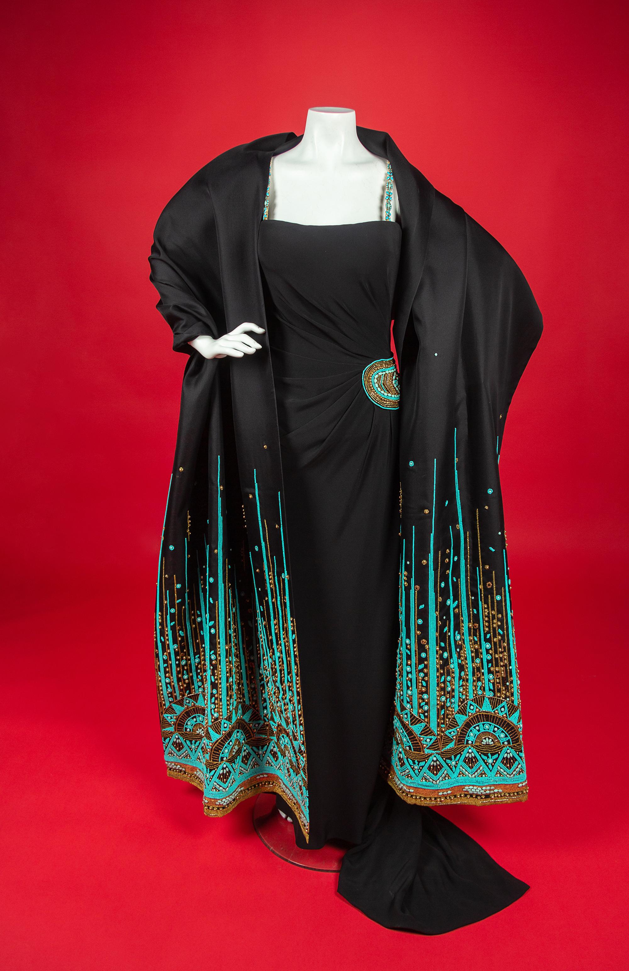Christian Dior Haute Couture Dress and Shawl, 2008 — In 2008, Renée Fleming was the first woman to open the season of New York’s Metropolitan Opera. For the occasion, she wore four haute couture creations, including this dress by John Galliano for Christian Dior for her role as The Countess in Strauss’s Capriccio. Annie Lebovitz photographed Fleming in all four dresses for a 2008 Vogue article called ‘La Dolce Vida’ by Hamish Bowles. In the article, Galliano is quote as saying that Fleming’s voice, with its ‘whole timbre of colors, emotions, and tones, made me want to create something bold, vivacious, sensual, and capricious.’