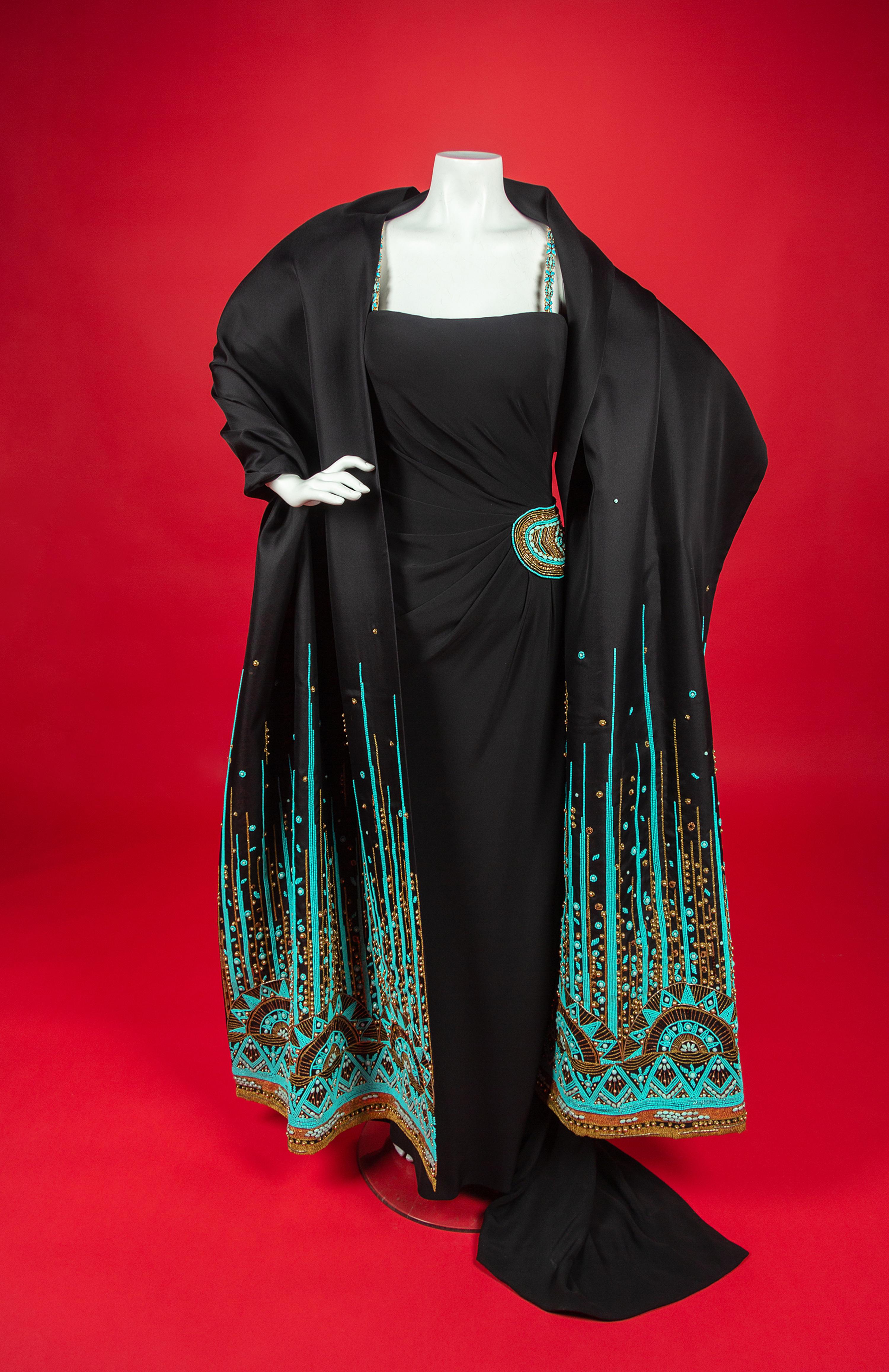 Christian Dior Haute Couture Dress and Shawl, 2008 — In 2008, Renée Fleming was the first woman to open the season of New York’s Metropolitan Opera. For the occasion, she wore four haute couture creations, including this dress by John Galliano for Christian Dior for her role as The Countess in Strauss’s Capriccio. Annie Lebovitz photographed Fleming in all four dresses for a 2008 Vogue article called ‘La Dolce Vida’ by Hamish Bowles. In the article, Galliano is quote as saying that Fleming’s voice, with its ‘whole timbre of colors, emotions, and tones, made me want to create something bold, vivacious, sensual, and capricious.’