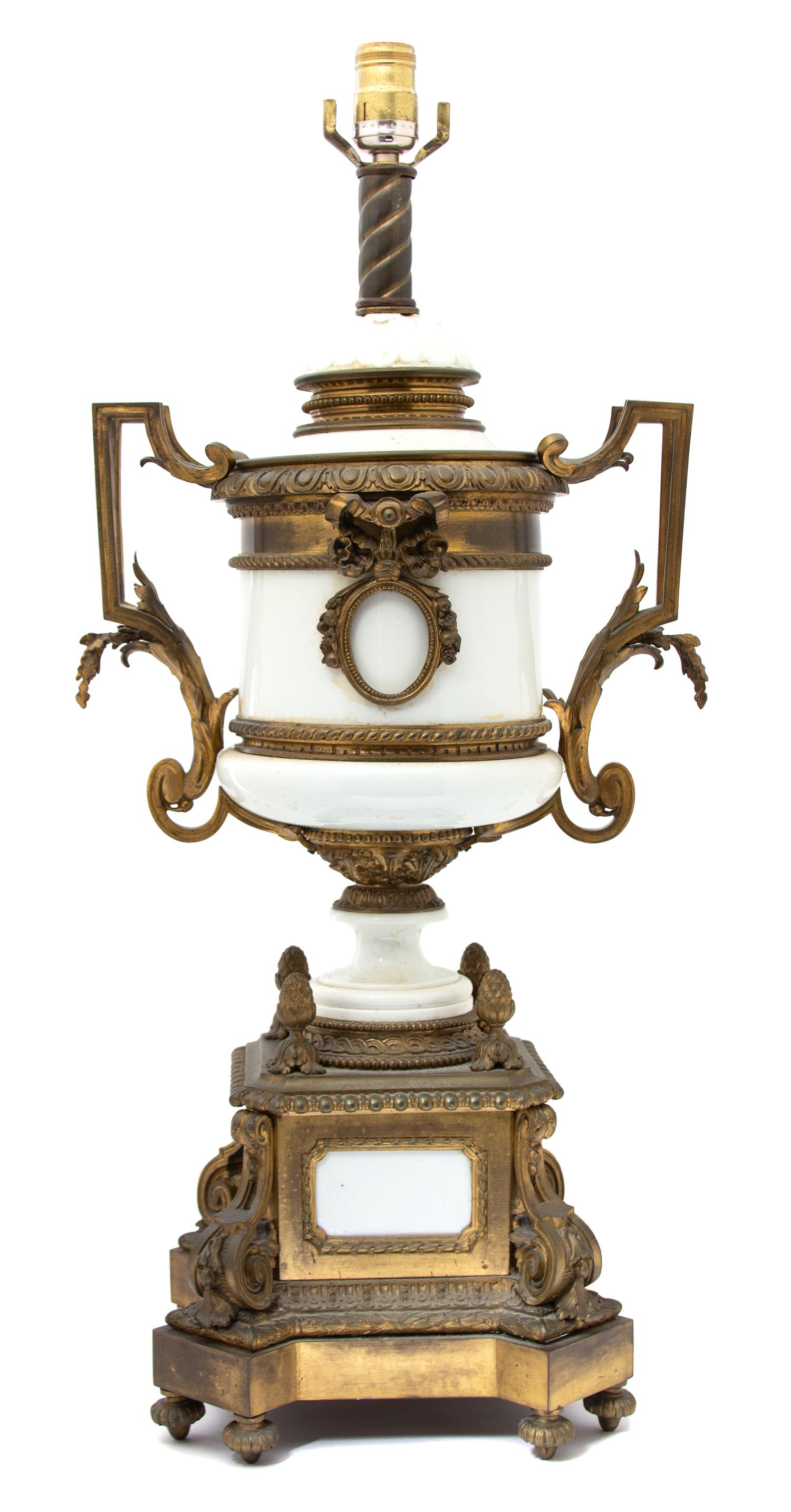 A Louis XVI Style Gilt Bronze Mounted White Ceramic Urn-form Lamp Height to bulb 28 x width 13 x depth 10 inches. — EARLY 20TH CENTURY