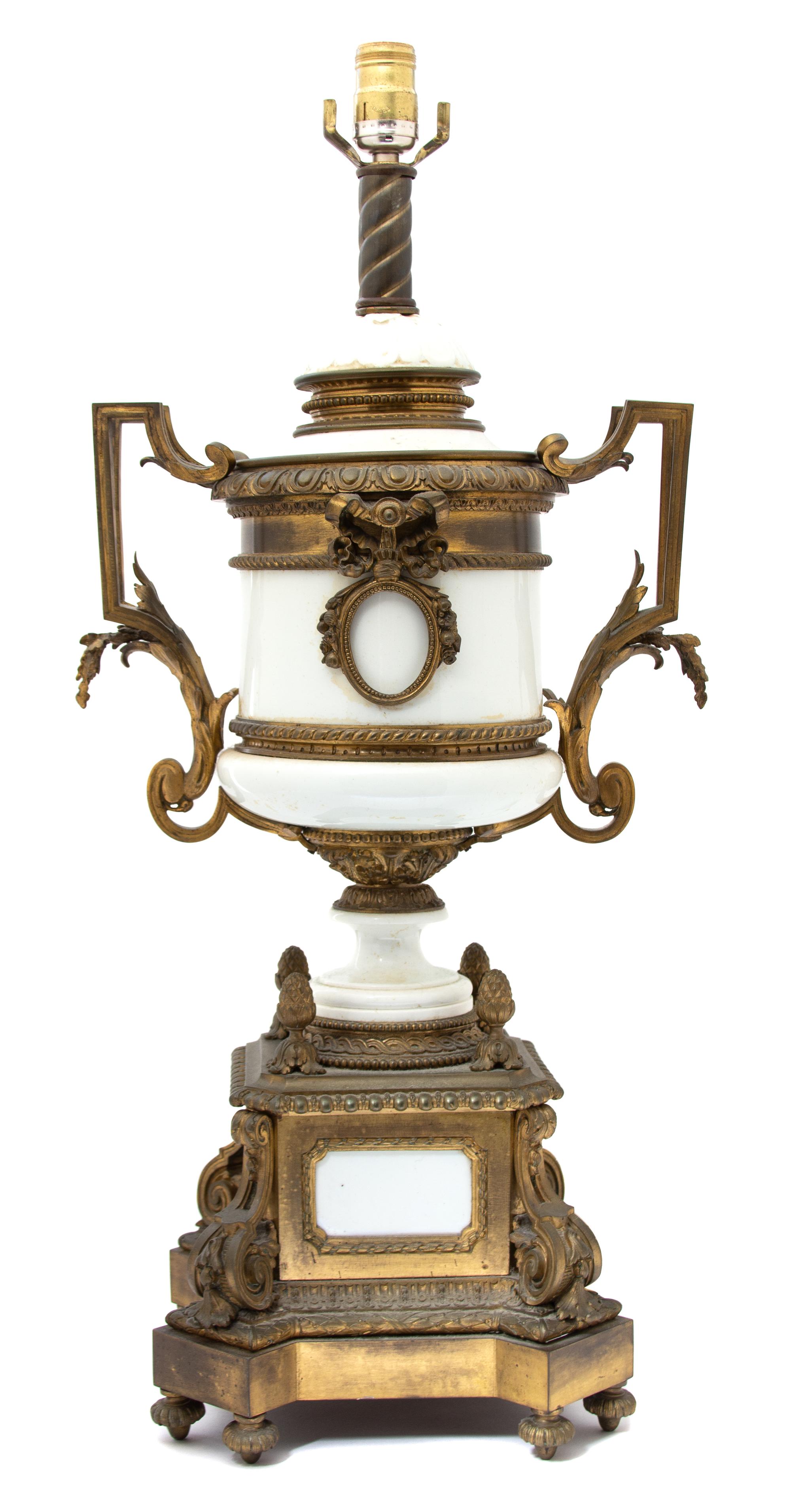A Louis XVI Style Gilt Bronze Mounted White Ceramic Urn-form Lamp Height to bulb 28 x width 13 x depth 10 inches. — EARLY 20TH CENTURY