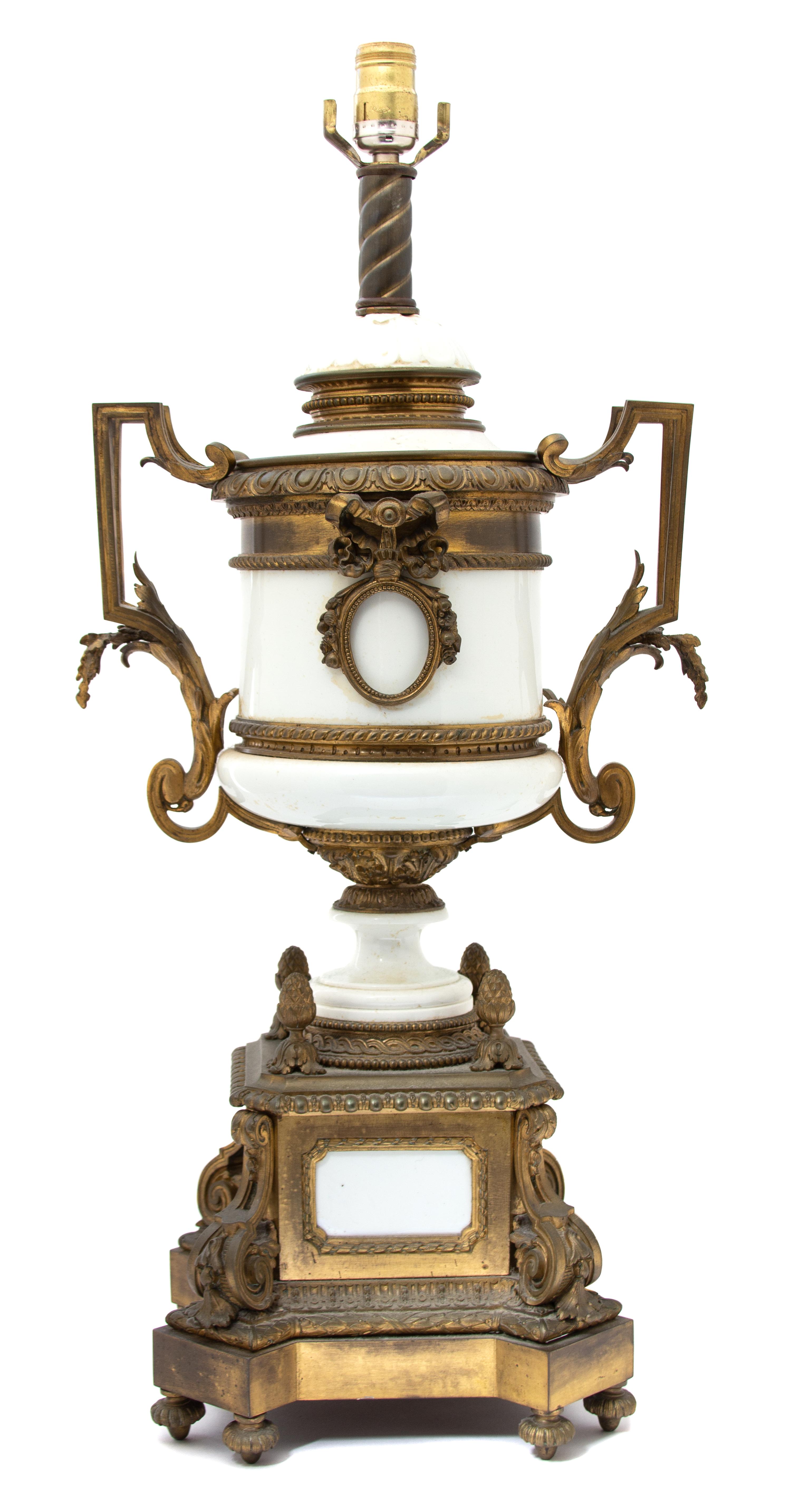 A Louis XVI Style Gilt Bronze Mounted White Ceramic Urn-form Lamp Height to bulb 28 x width 13 x depth 10 inches. — EARLY 20TH CENTURY