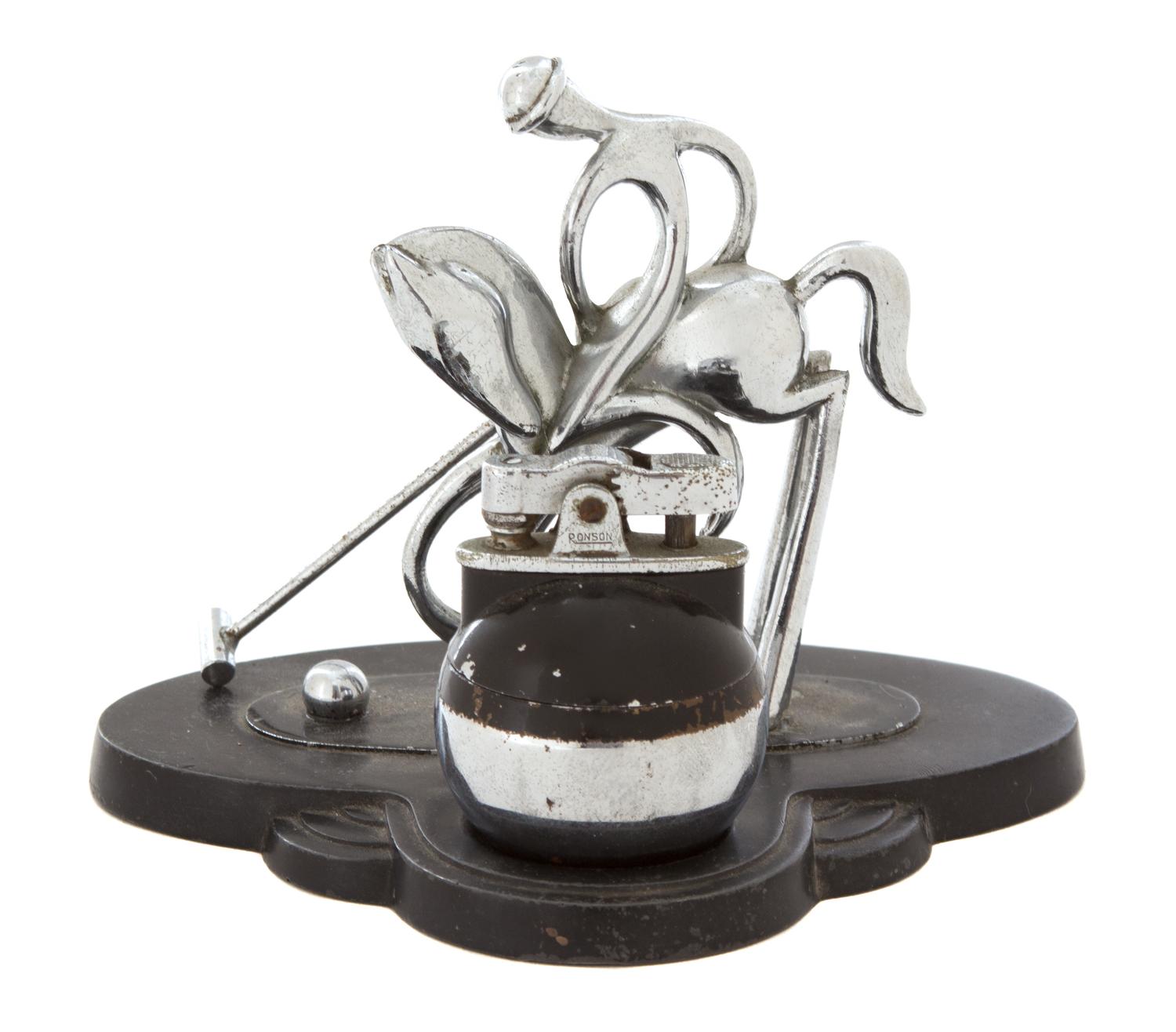 A Chromed Metal Polo Player-Form Ronson Cigarette Lighter Stand Height 4 1/2 x width 5 1/8 x depth 4 inches. — 20TH CENTURY