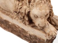 A Pair of Composition Marble Recumbent Lions