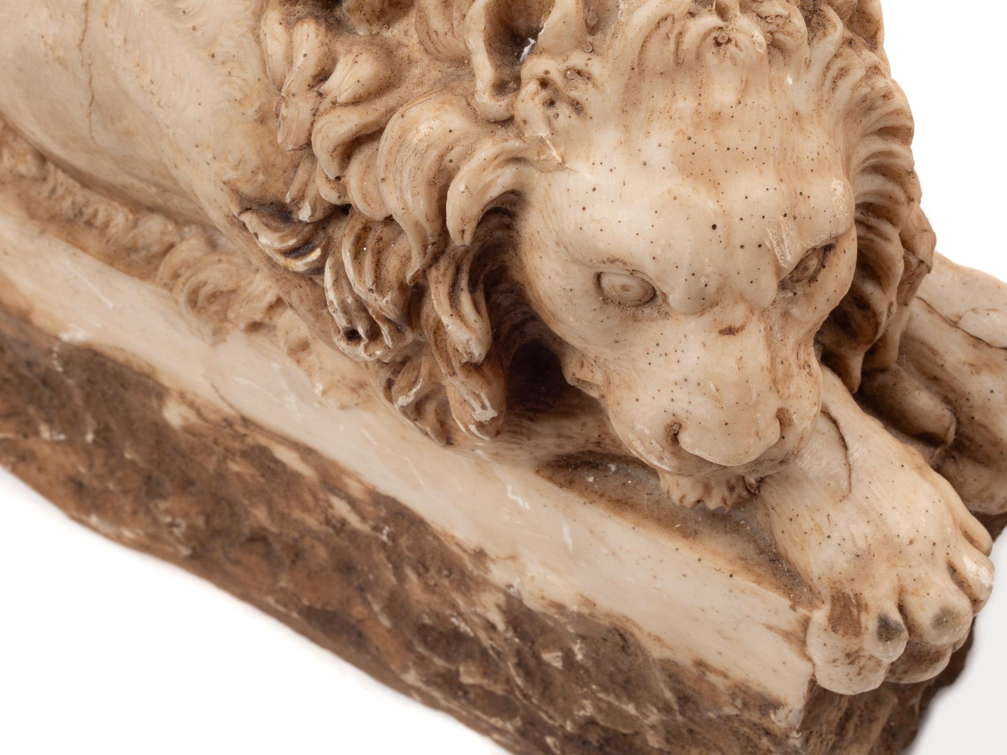 A Pair of Composition Marble Recumbent Lions