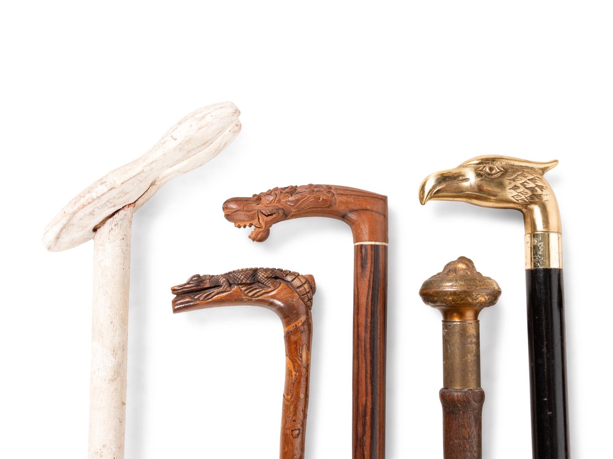 A Collection of Sixteen Carved and Mixed Metal Decorated Zoomorphic Walking Sticks