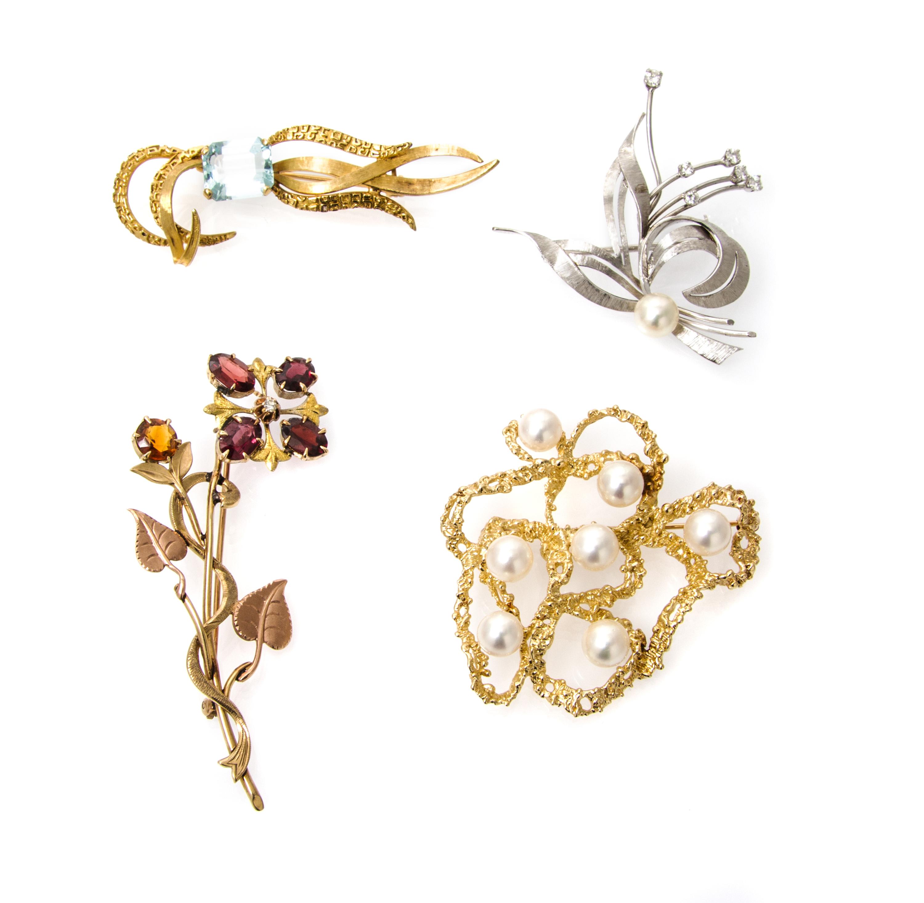 A Collection of Gold, Cultured Pearl, Diamond and Gemstone Brooches, 18.60 dwts.