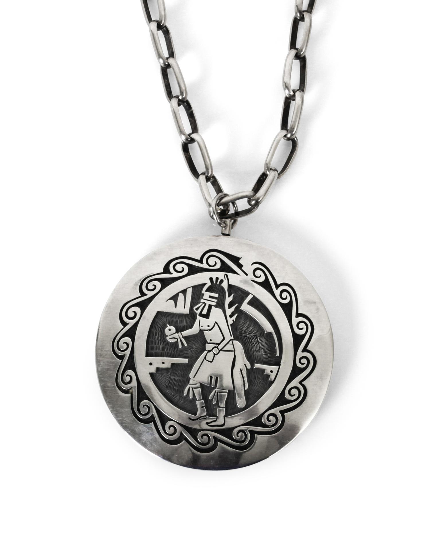 A Hopi Silver Overlay Two Sided "Spinner" Pendant Diameter 2 1/2 inches, length of chain 25 inches.