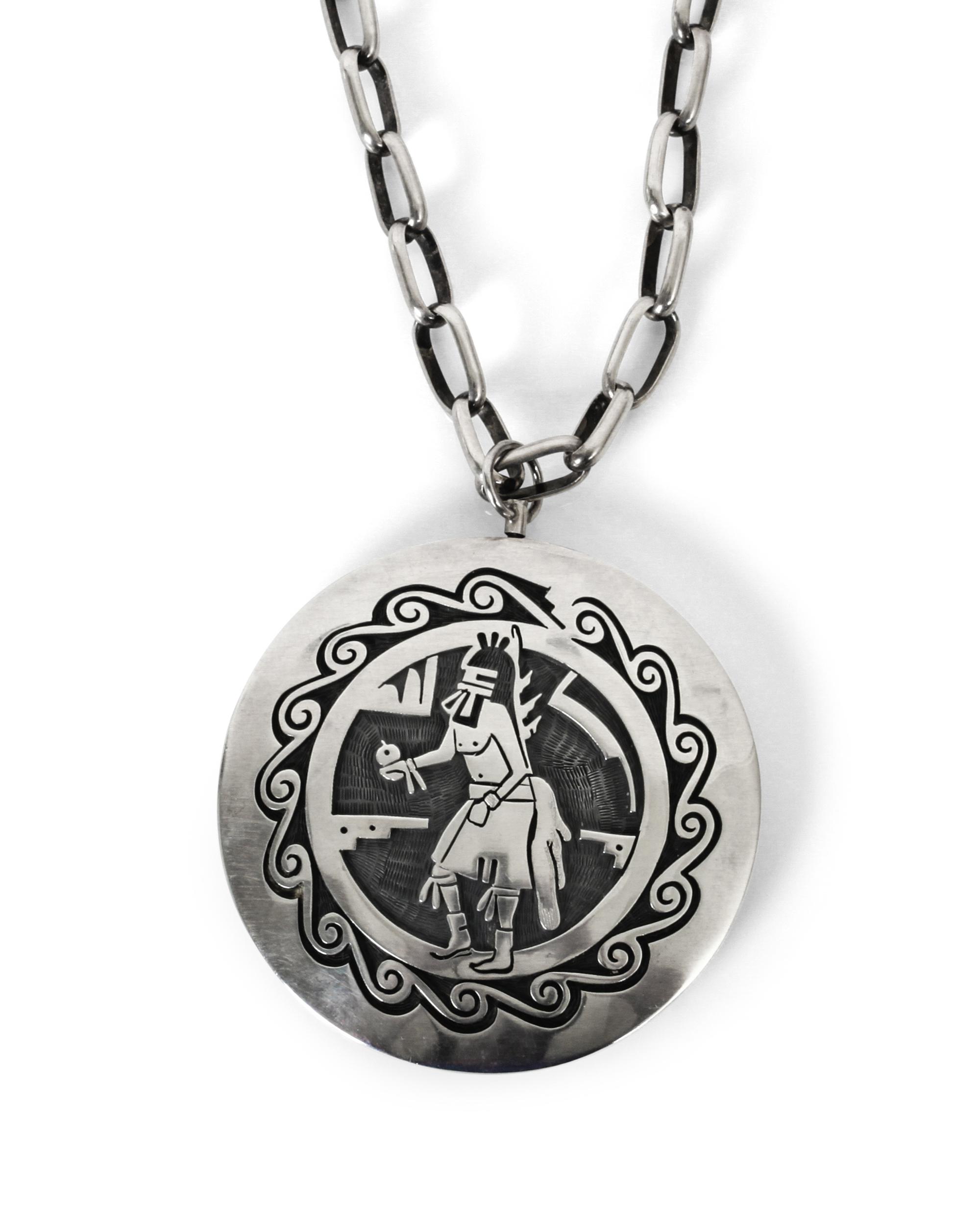 A Hopi Silver Overlay Two Sided "Spinner" Pendant Diameter 2 1/2 inches, length of chain 25 inches.