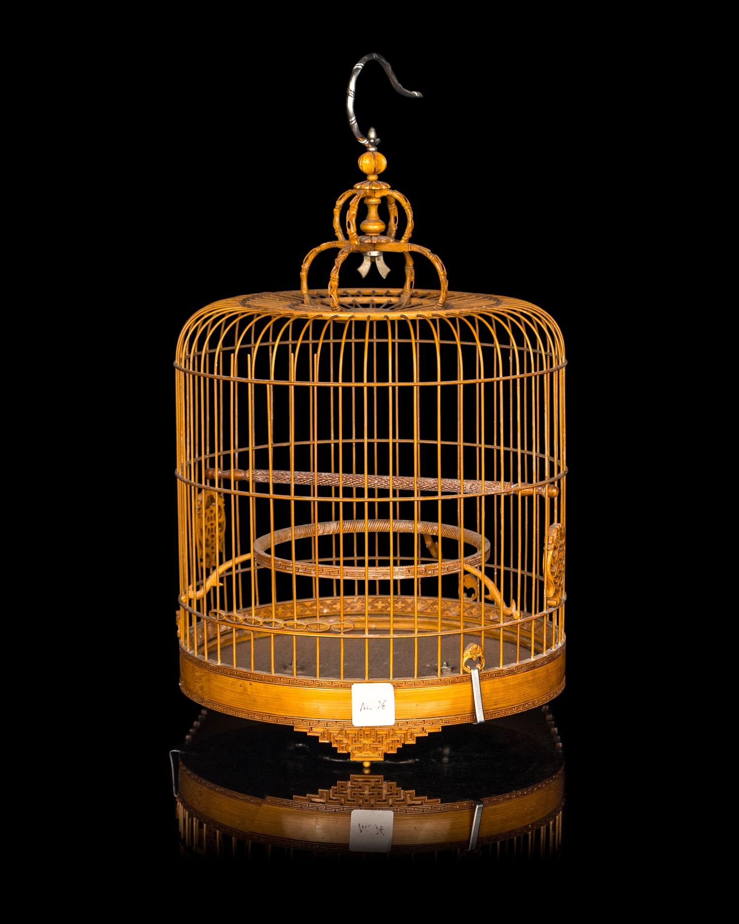 A Chinese Bamboo Bird Cage with A Pair of Wucai Porcelain Bird Feeders